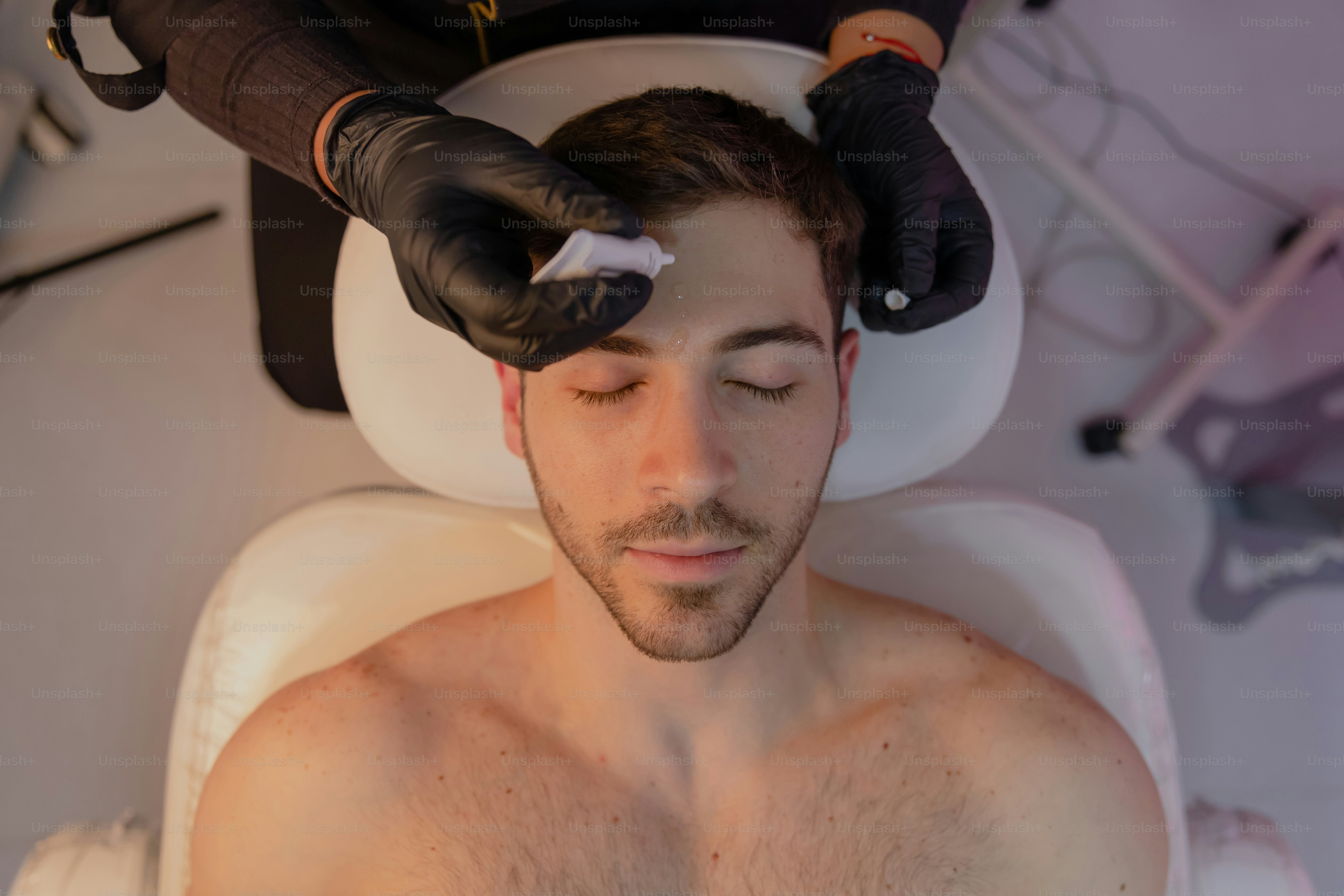 A man getting his hair cut by a hair stylist