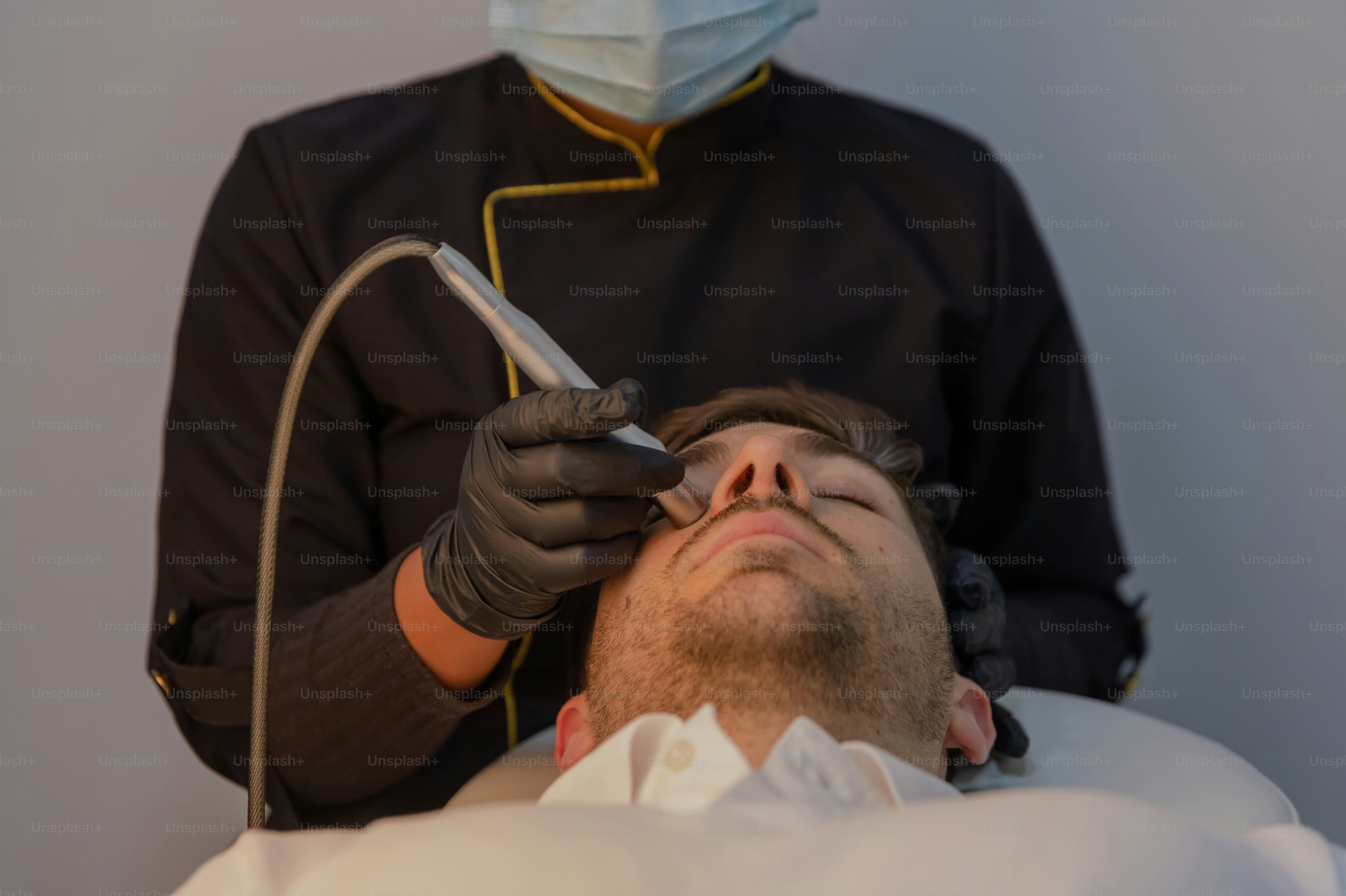 A man laying in a hospital bed with a medical mask on
