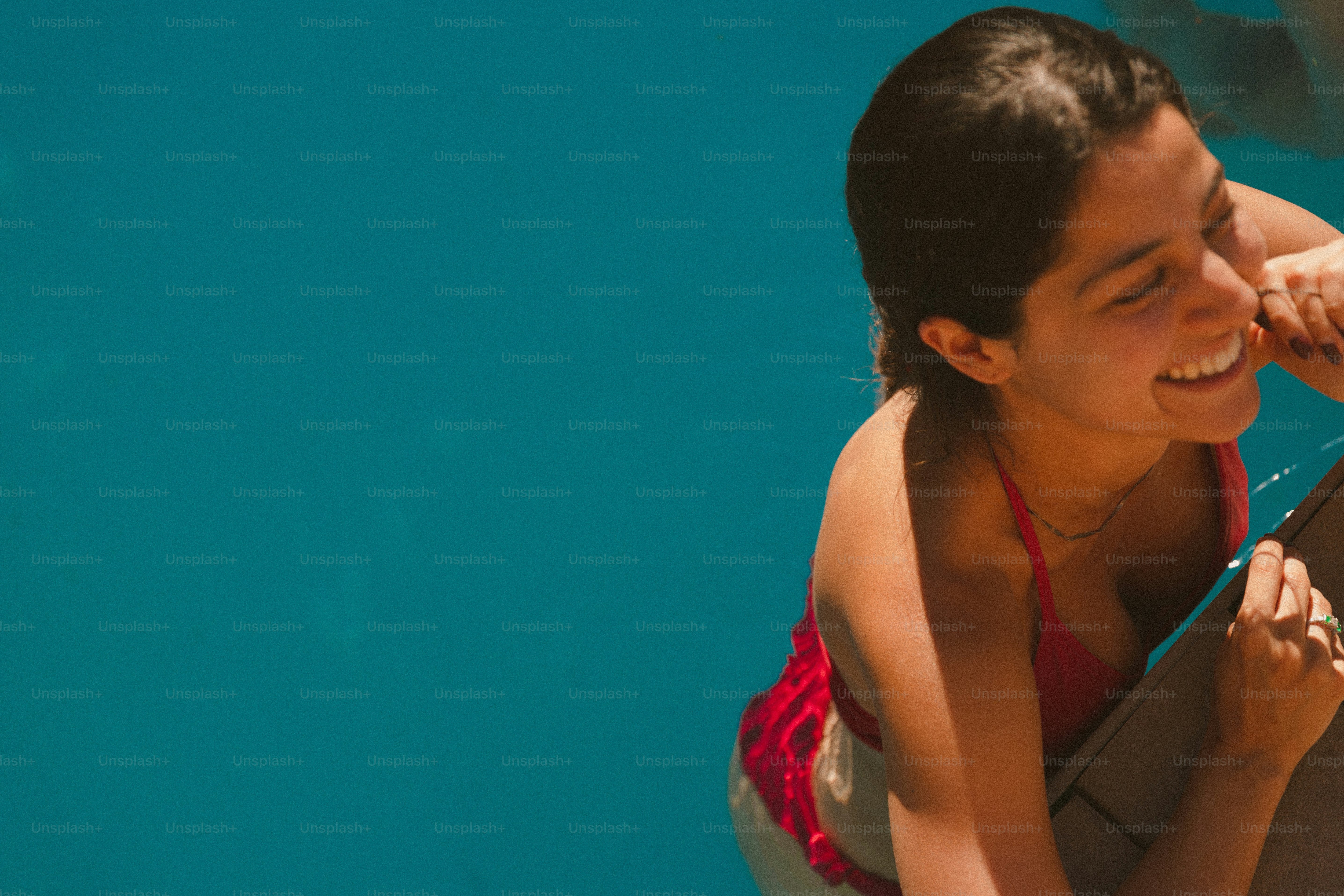 A woman in a red bikini holding a brown bag