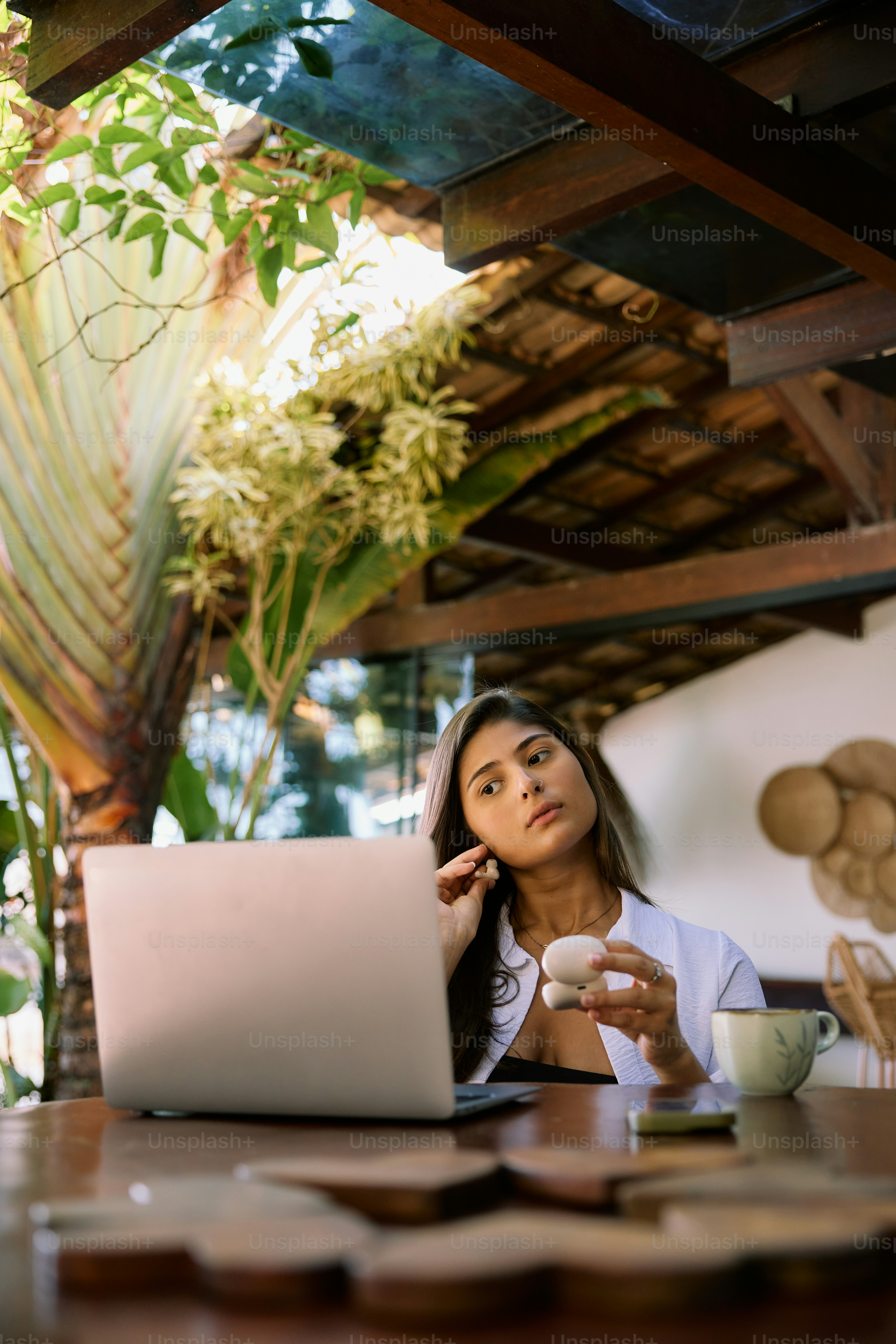 A woman sitting at a table with a laptop