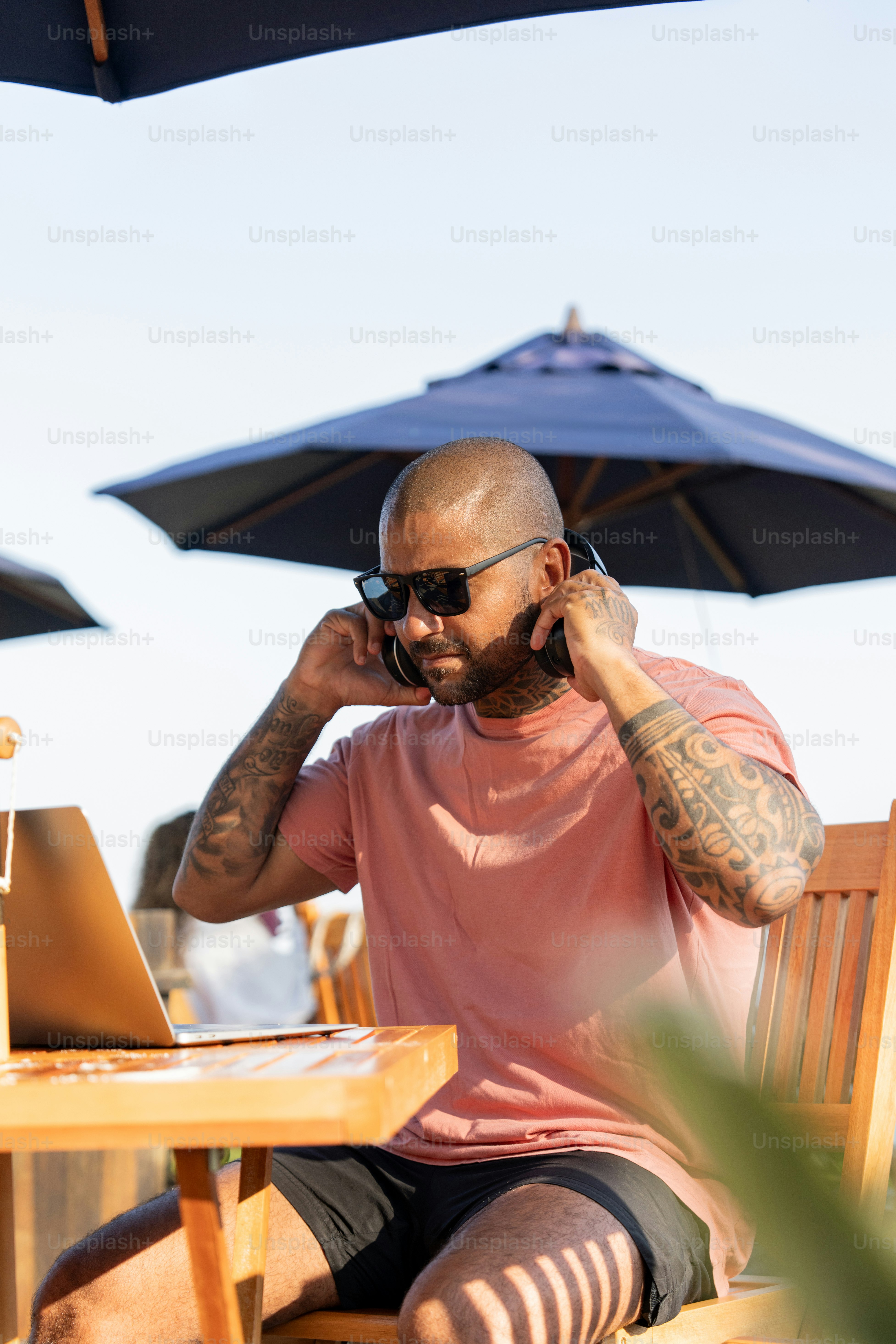 A man sitting at a table talking on a cell phone