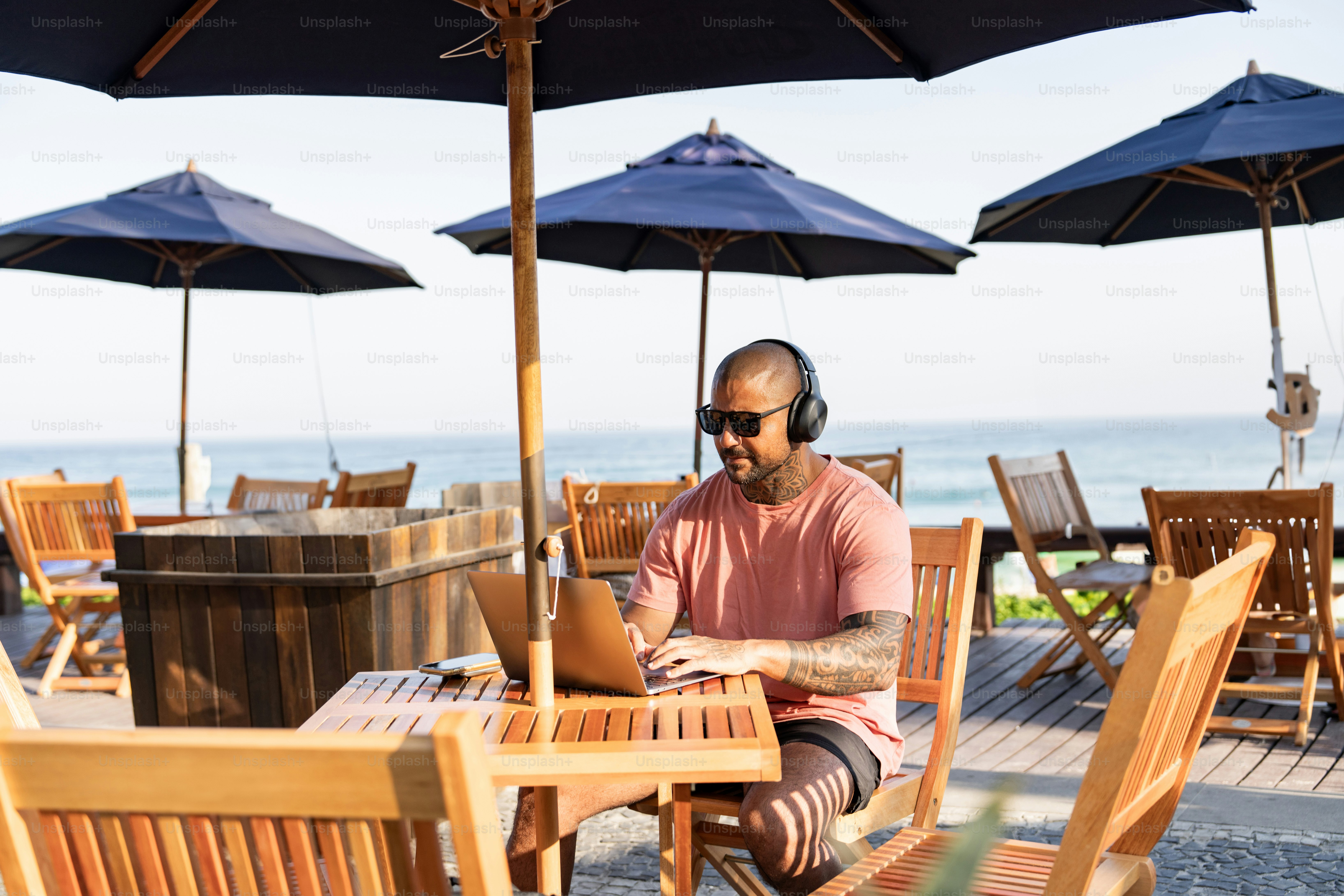 A man sitting at a table with headphones on