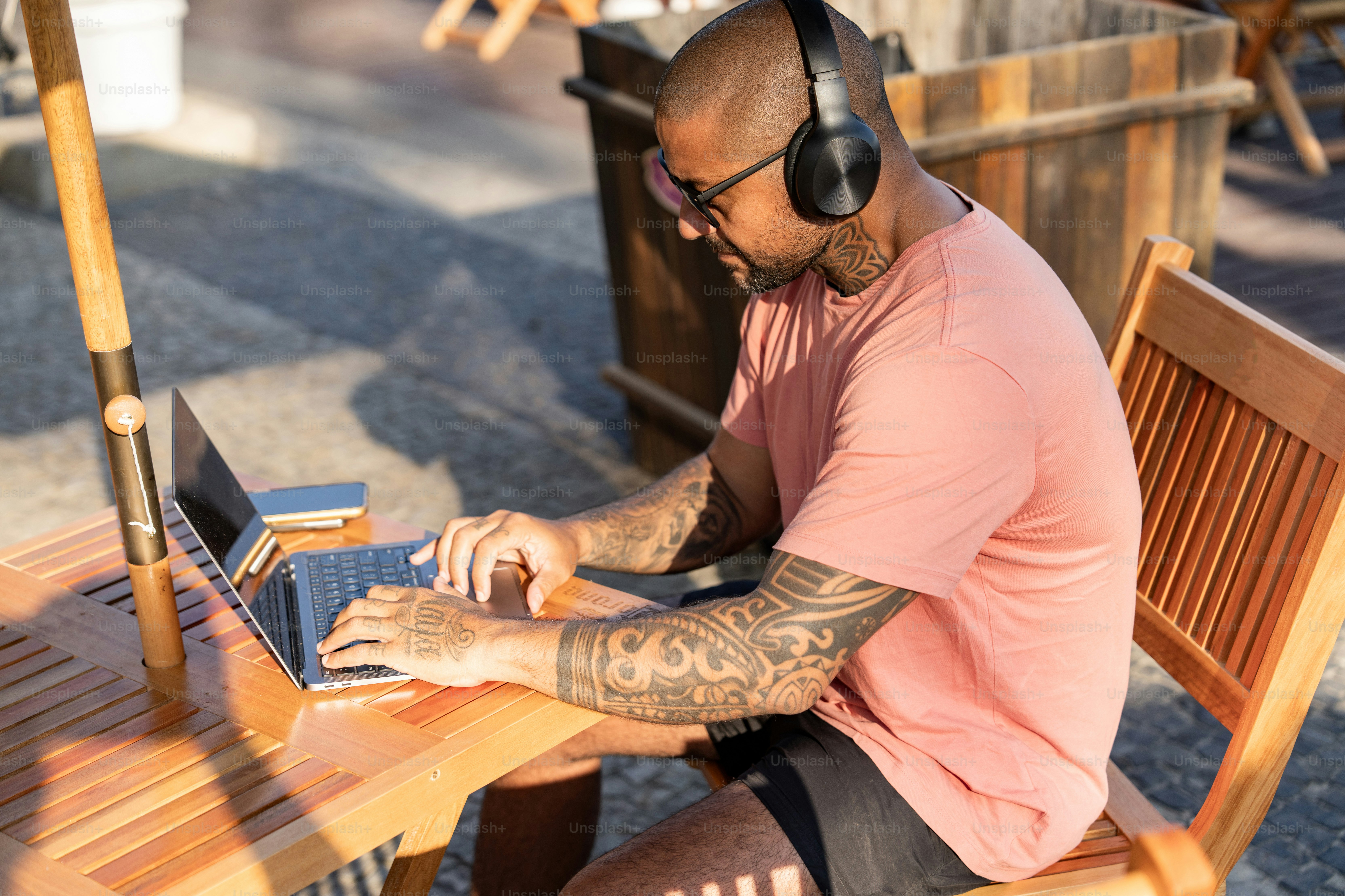 A man sitting at a table using a laptop computer