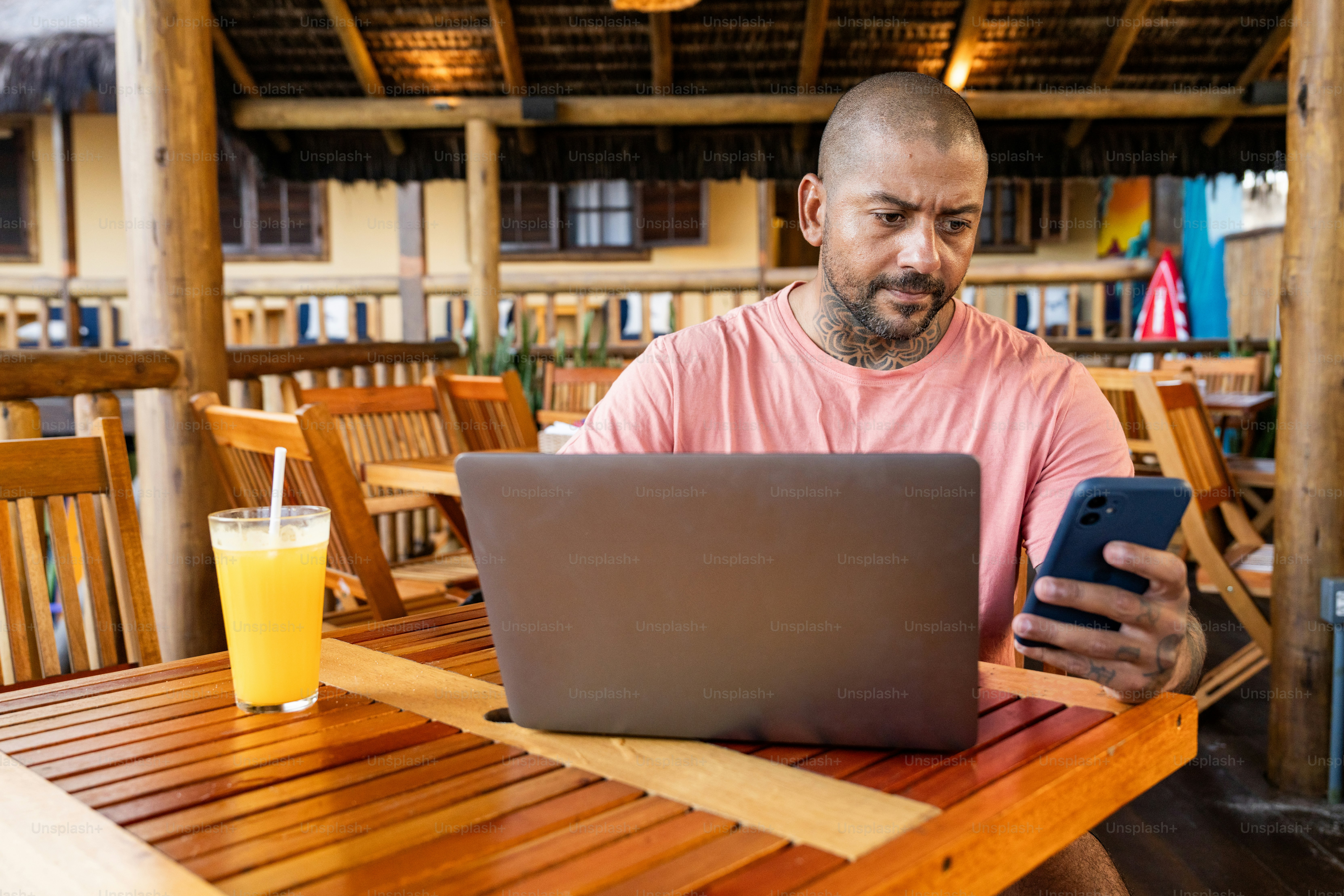A man sitting at a table using a laptop computer