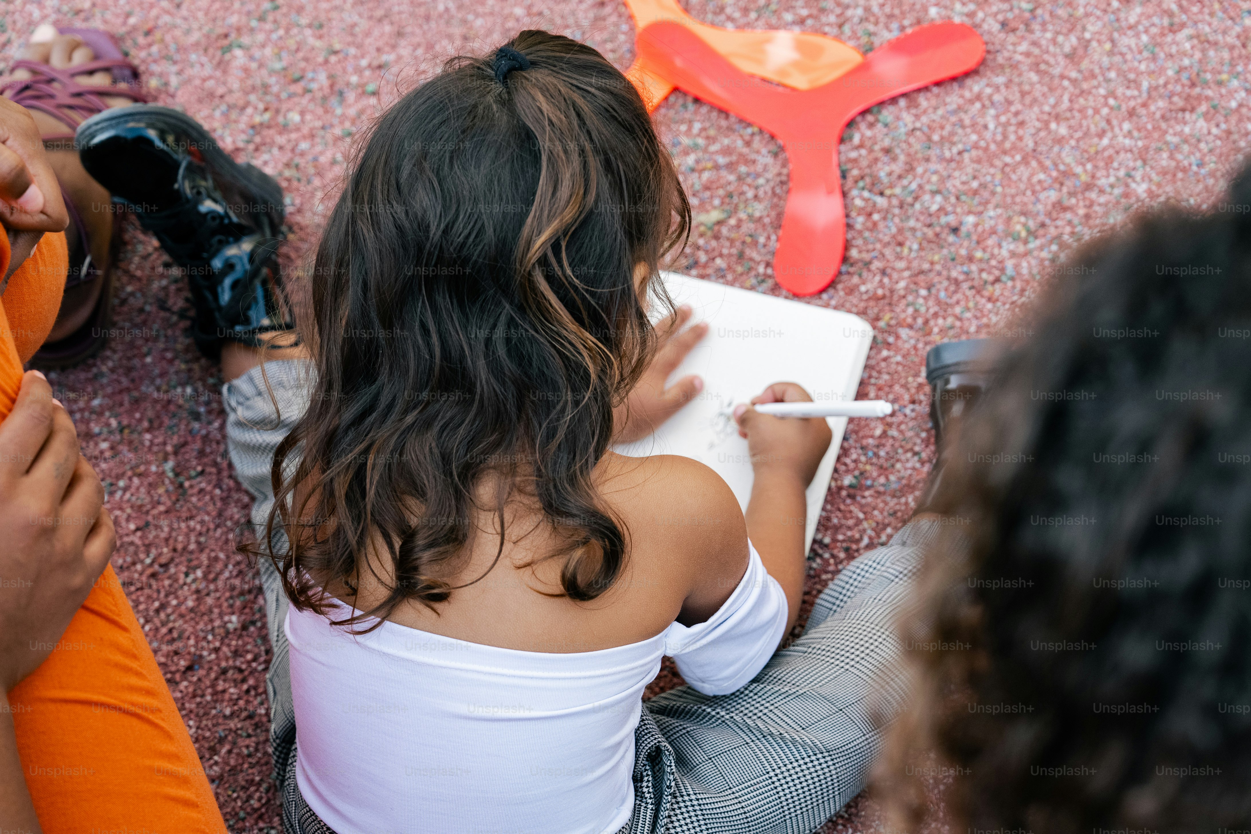 A group of people sitting on the ground