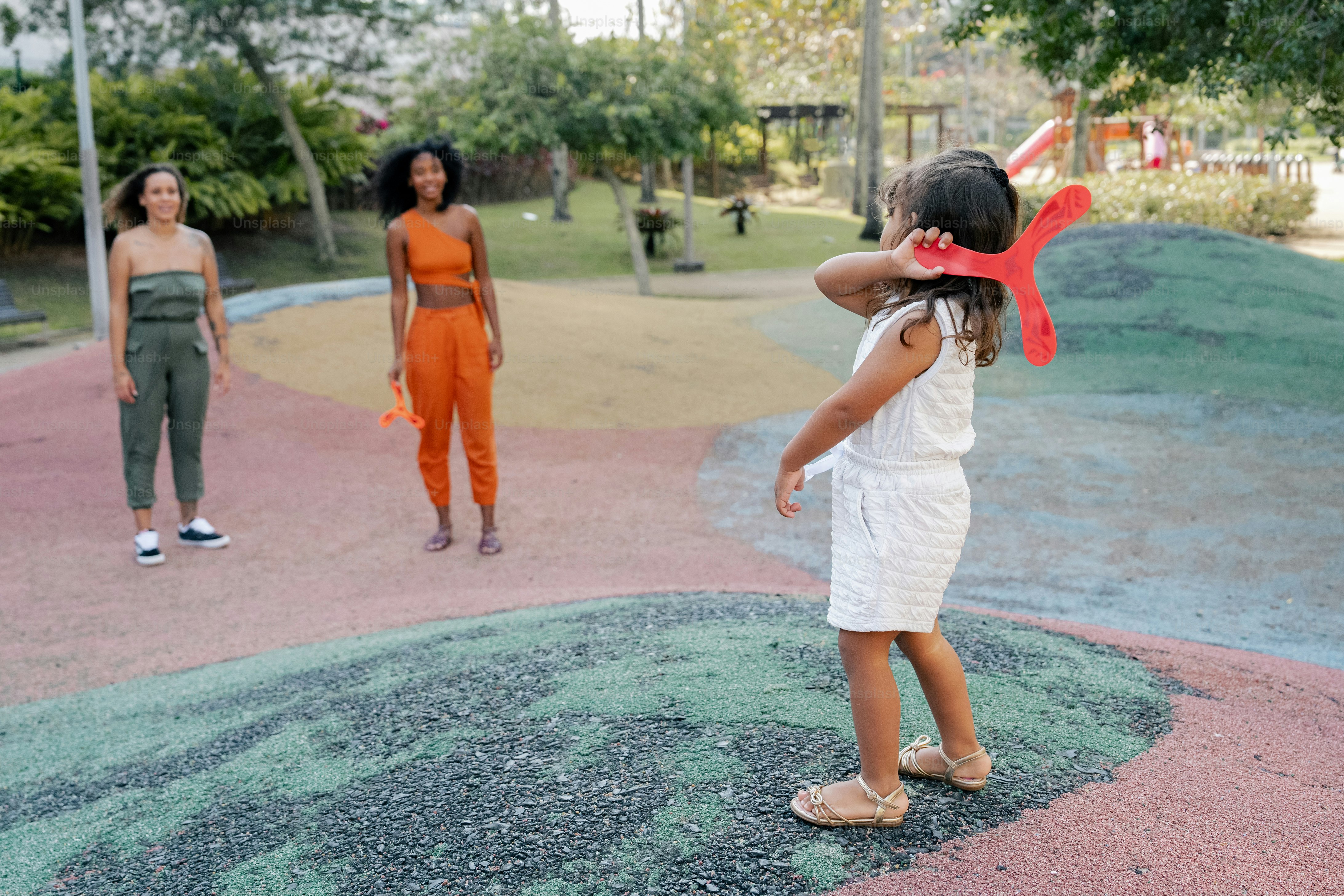 A group of young women standing around a park