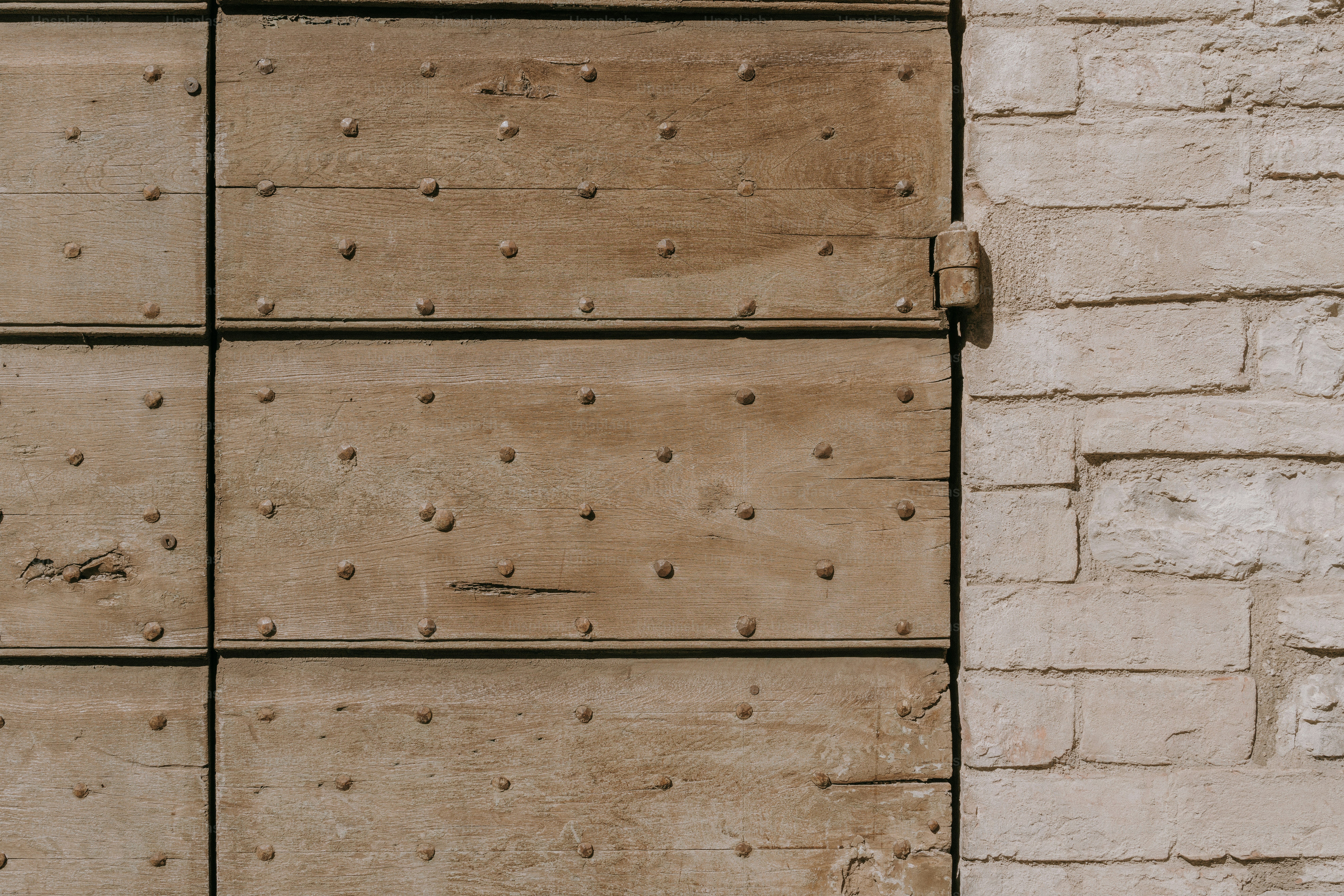 A white brick wall with holes in it