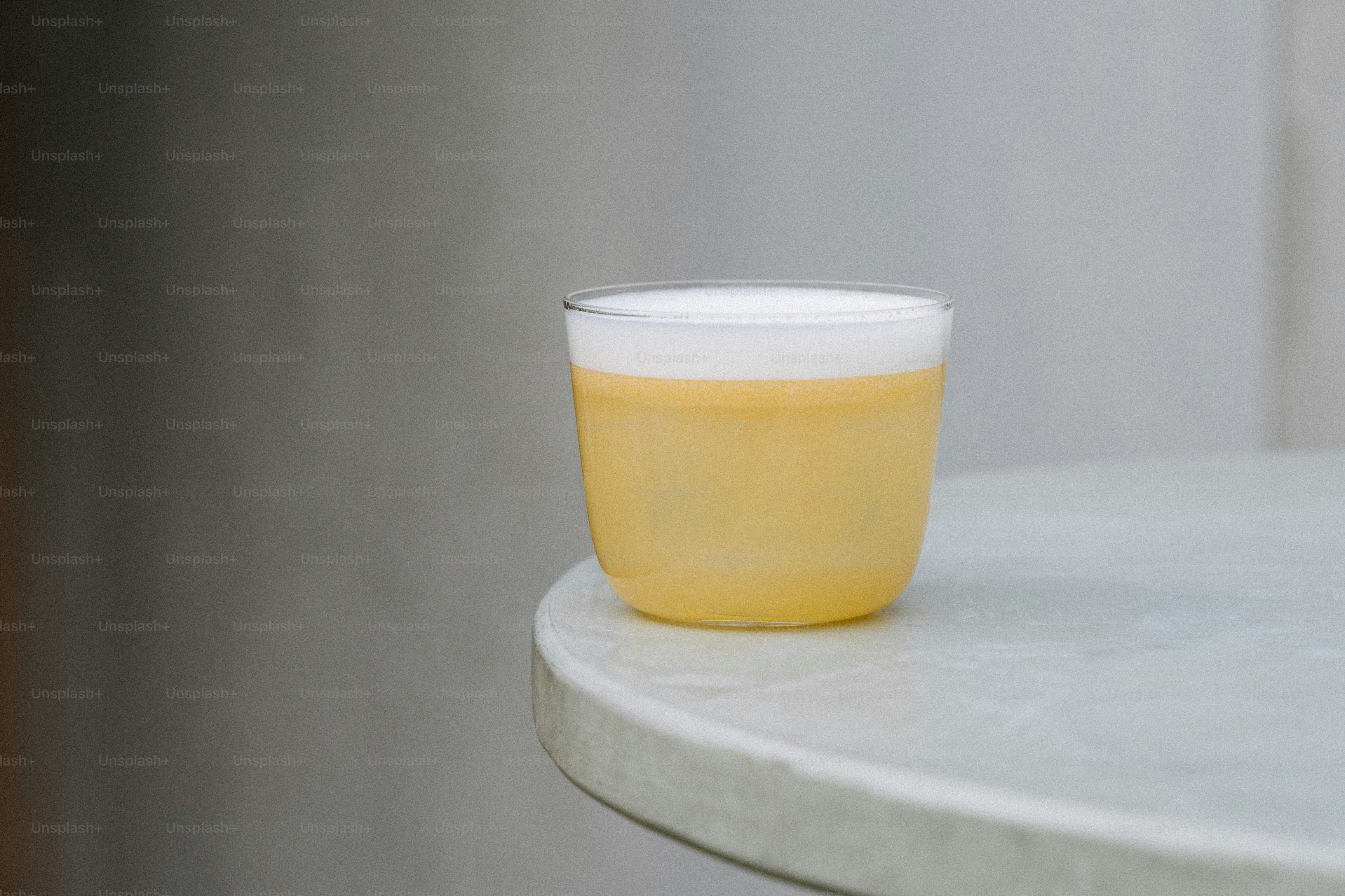 A yellow cup sitting on top of a white table
