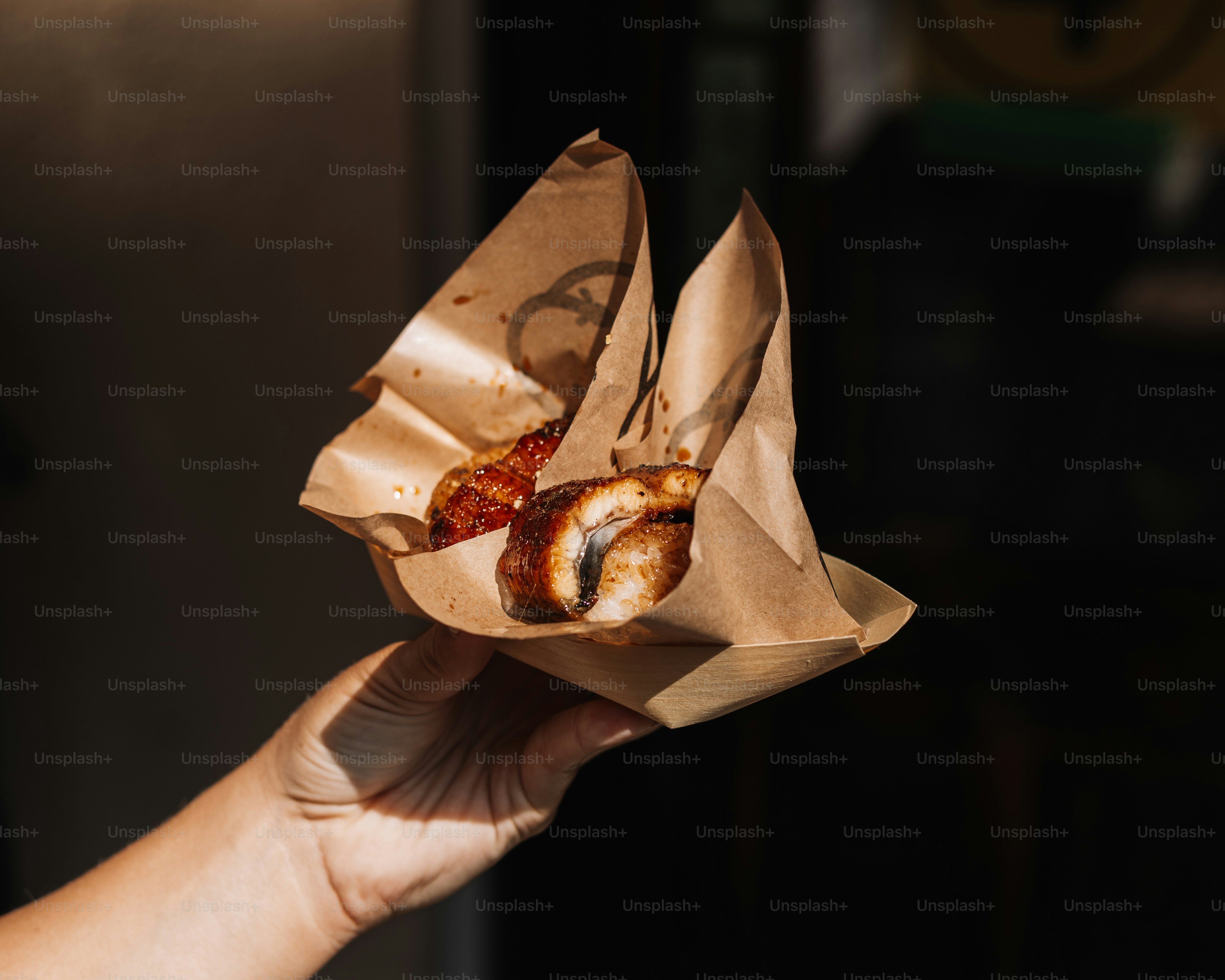 A person holding a piece of food in their hand