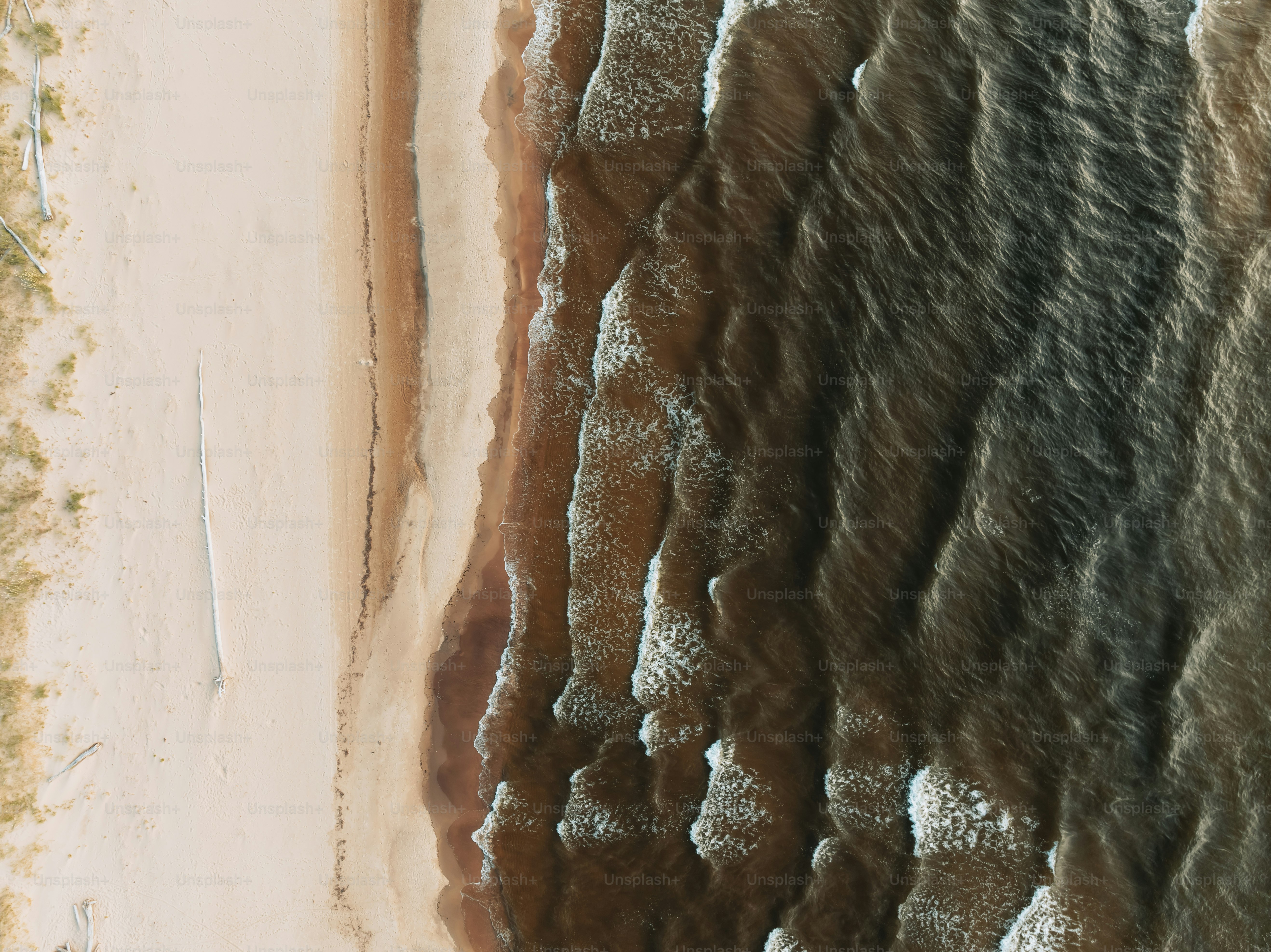An aerial view of a sandy beach and ocean