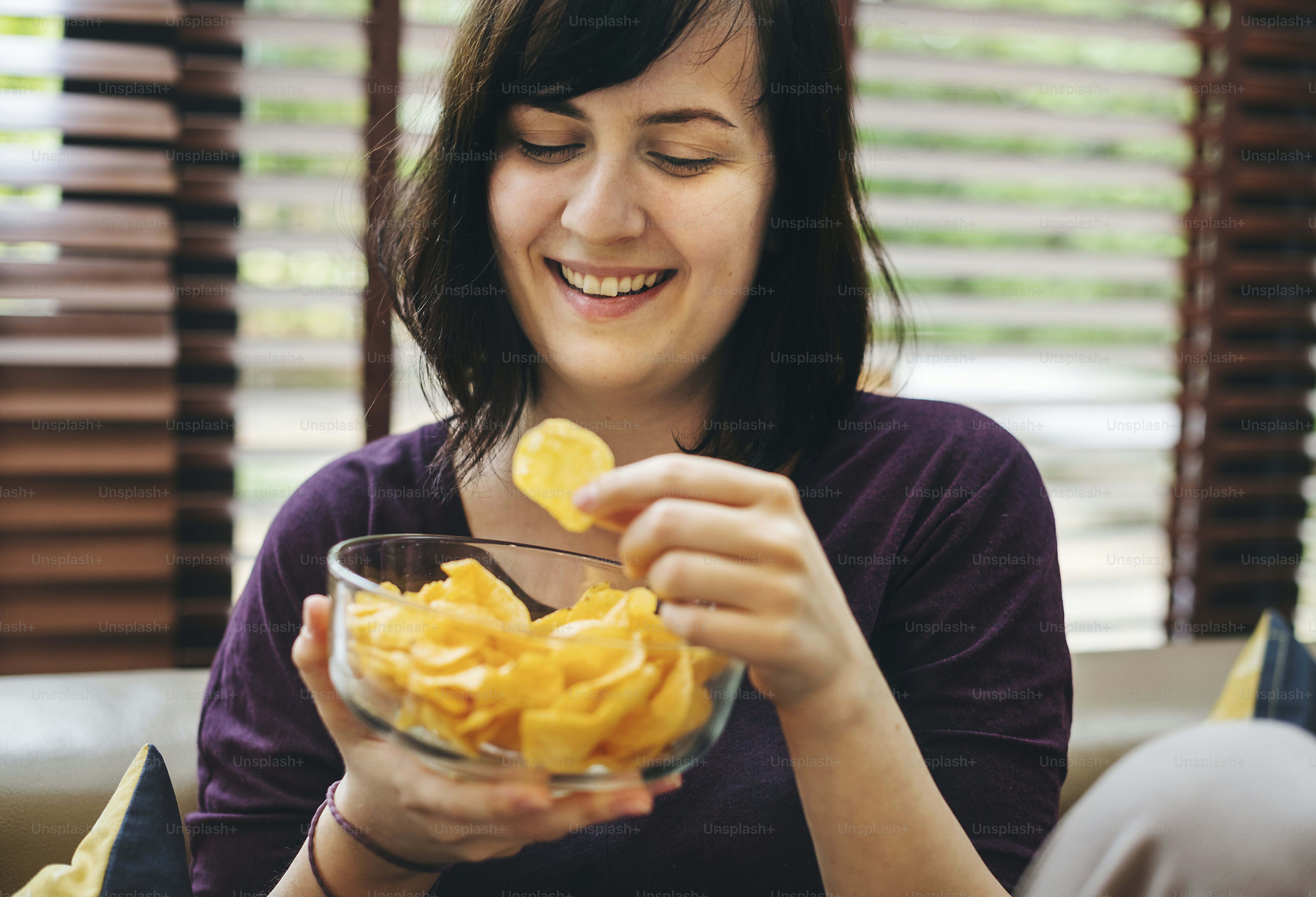 Woman enjoying a bowl of chips