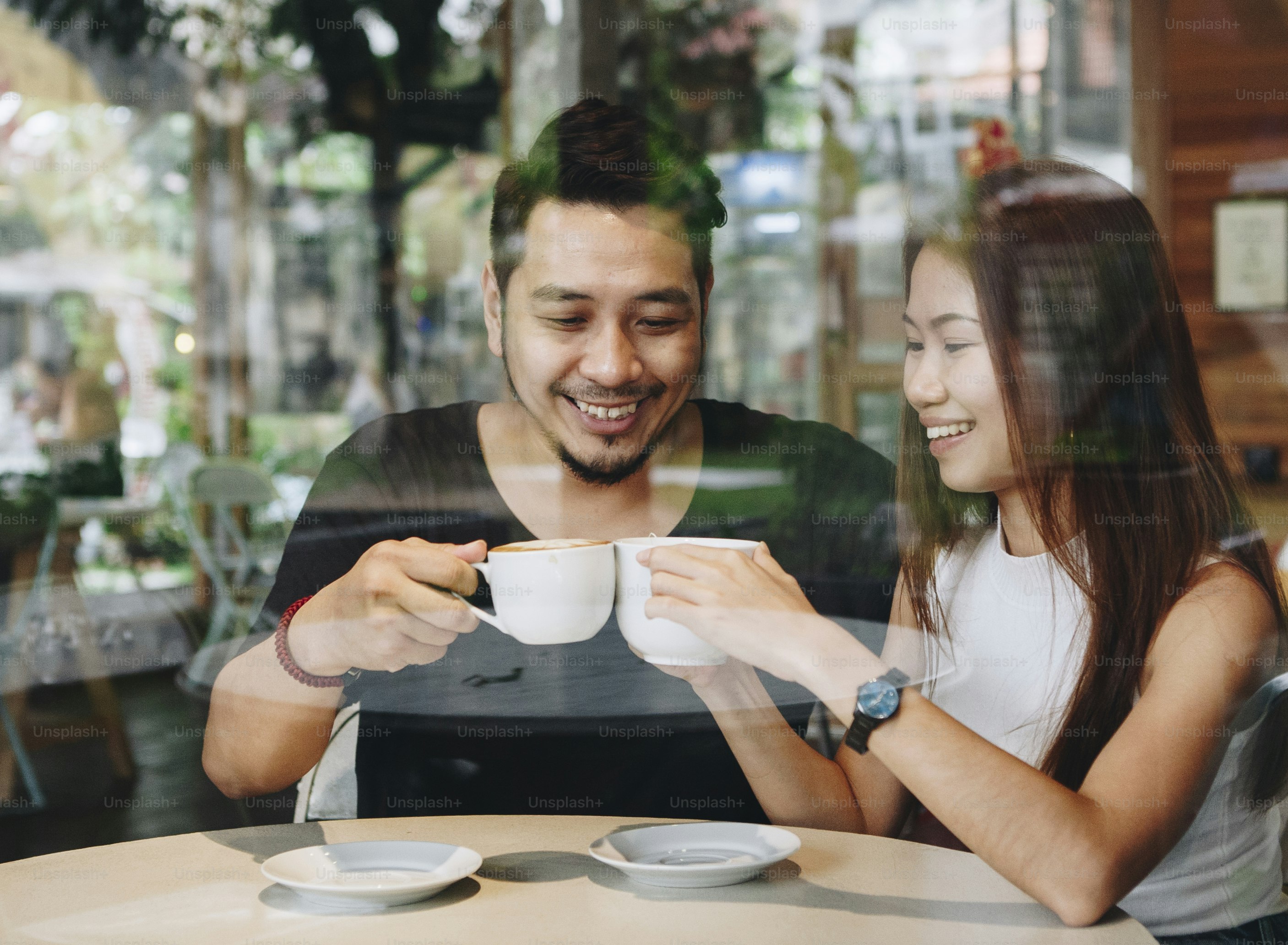 Lovely asian couple having coffee