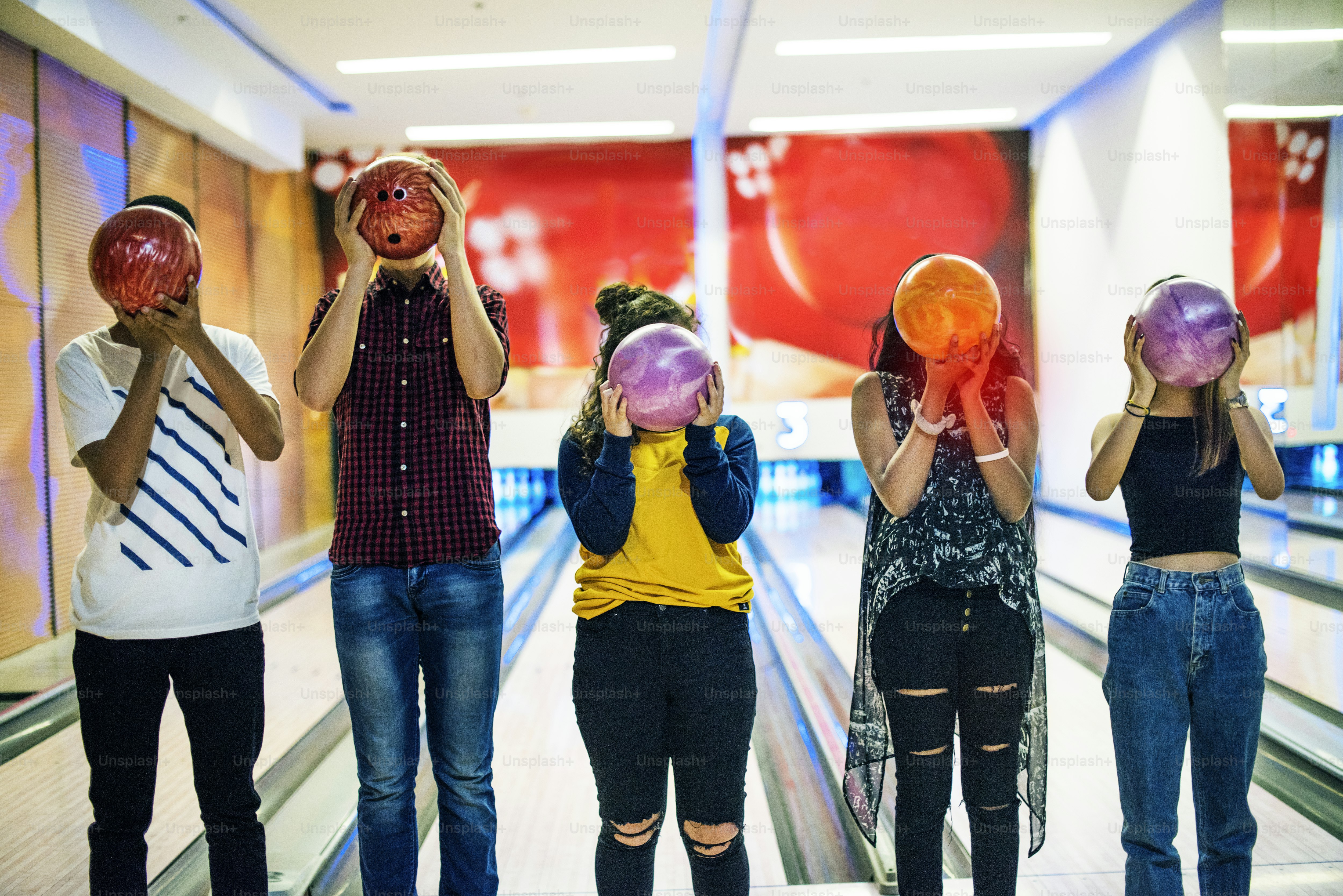Friends bowling together indoors