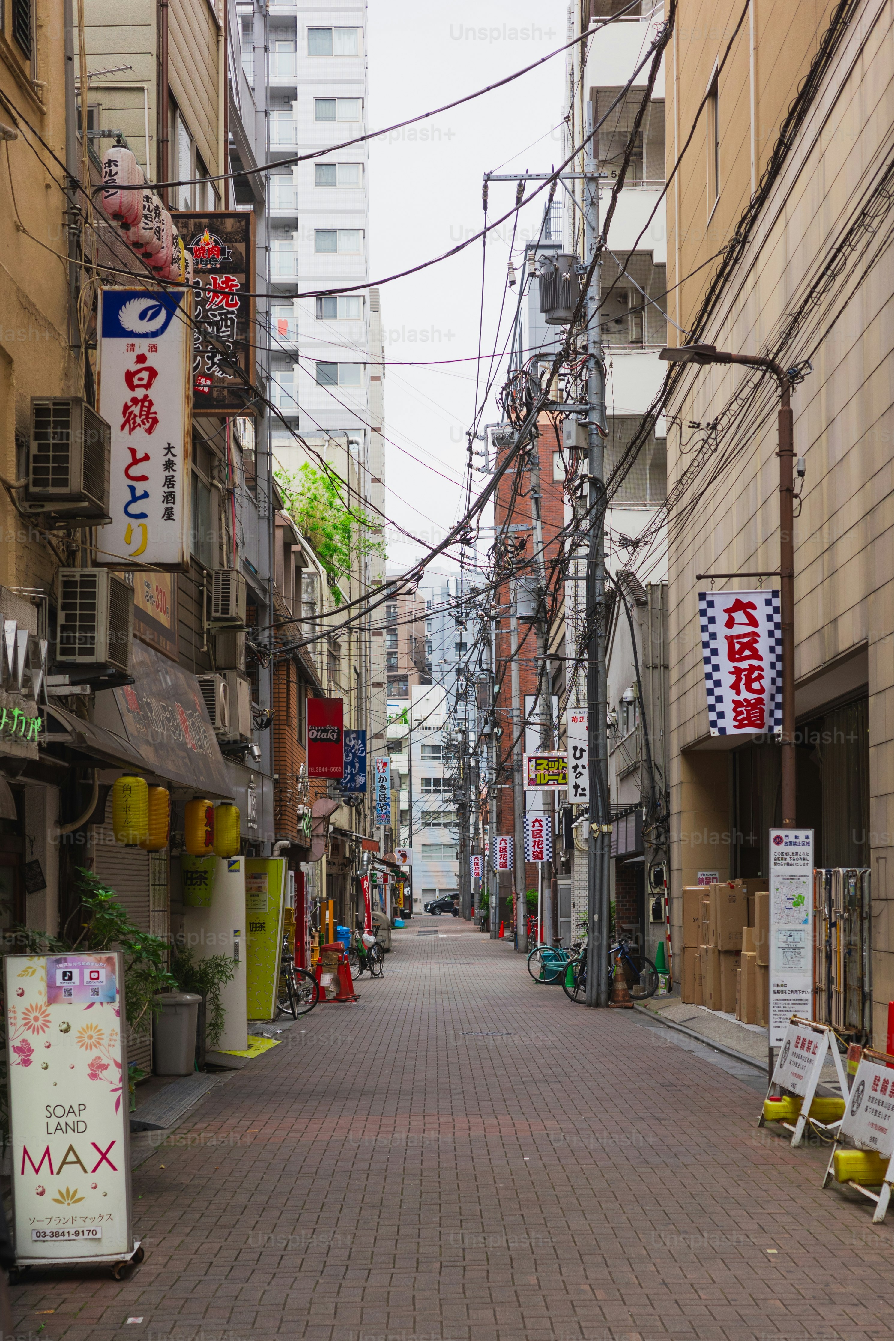 A narrow city street lined with tall buildings