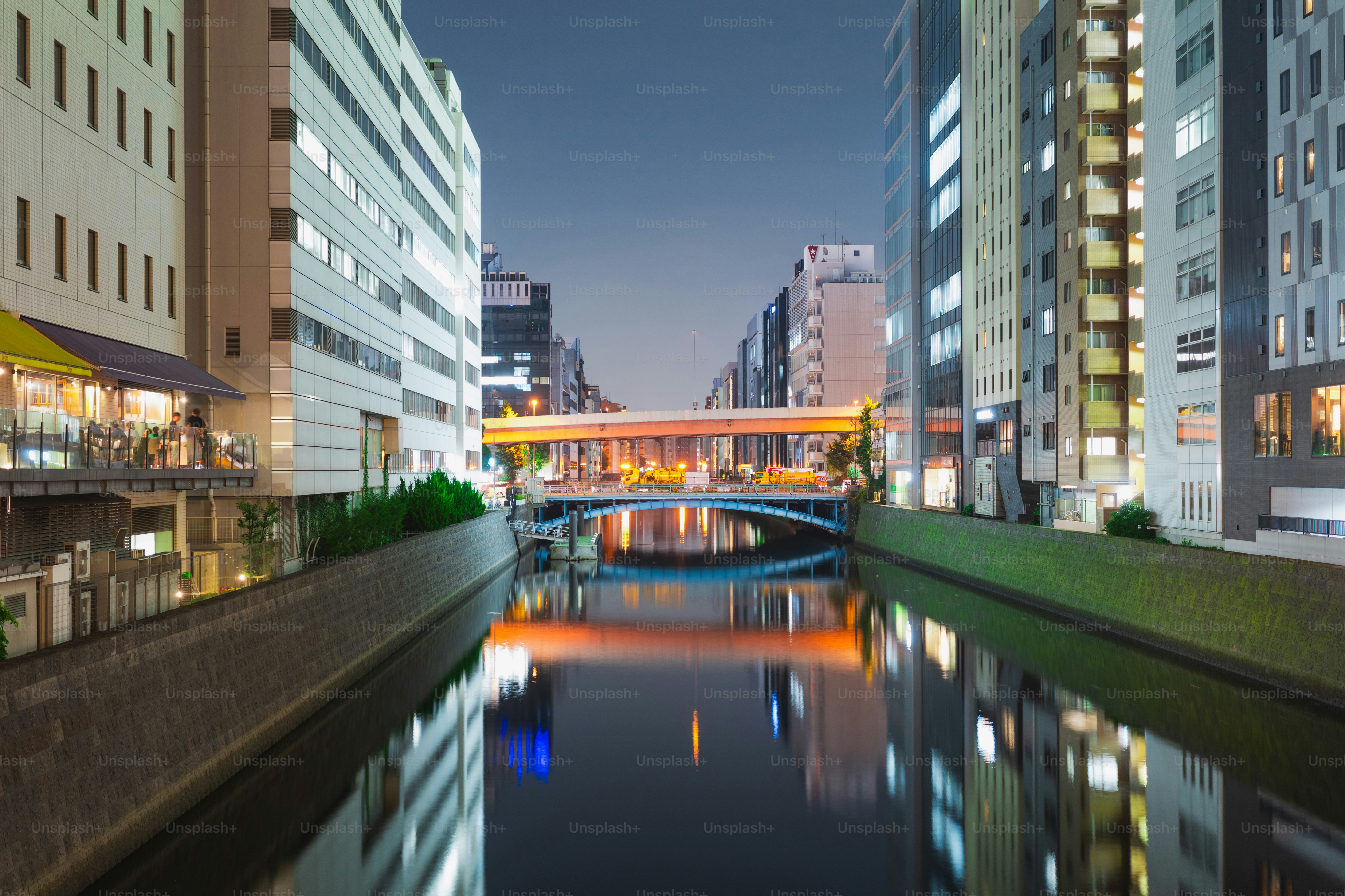 A river running through a city next to tall buildings