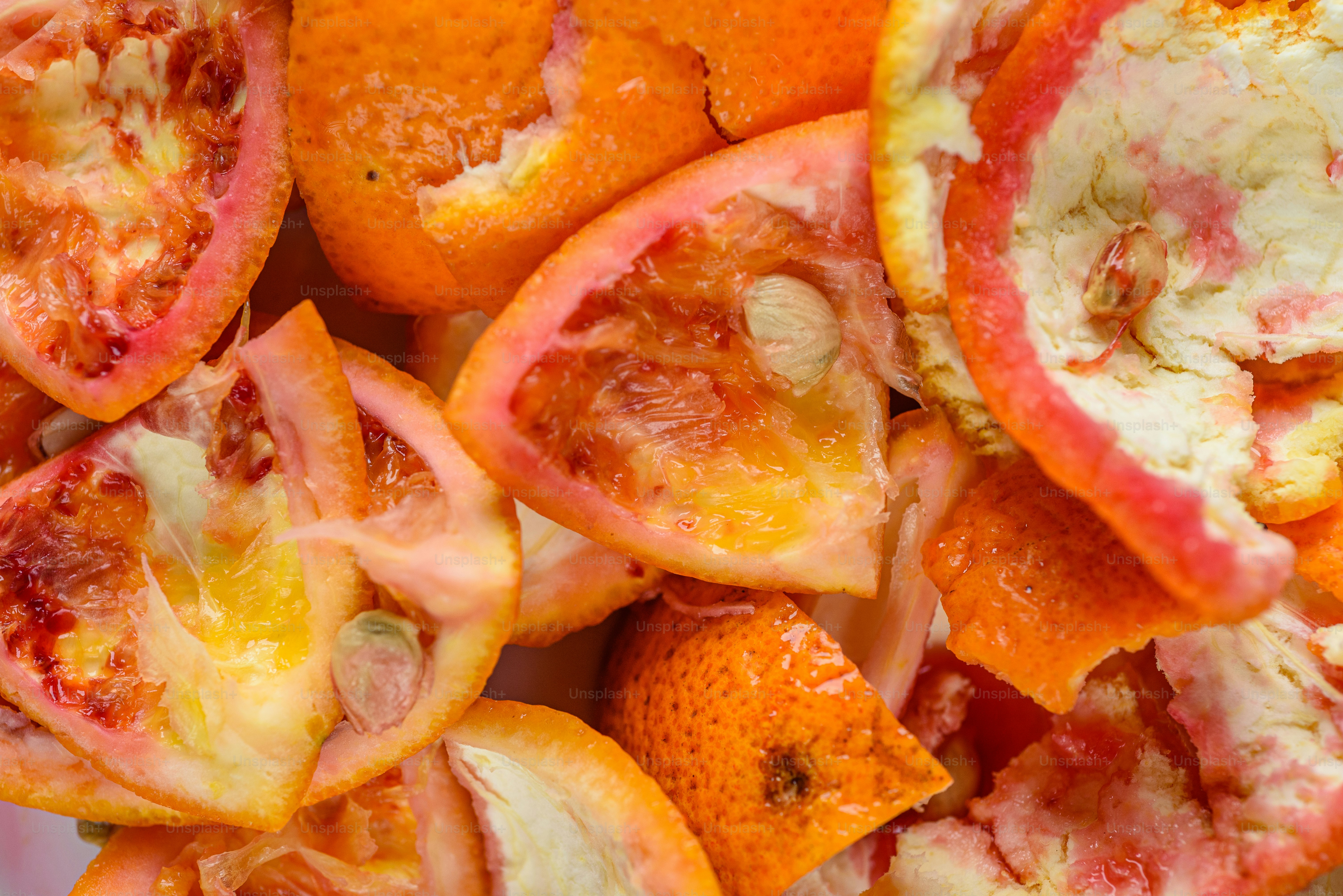 A pile of sliced up oranges sitting on top of a table