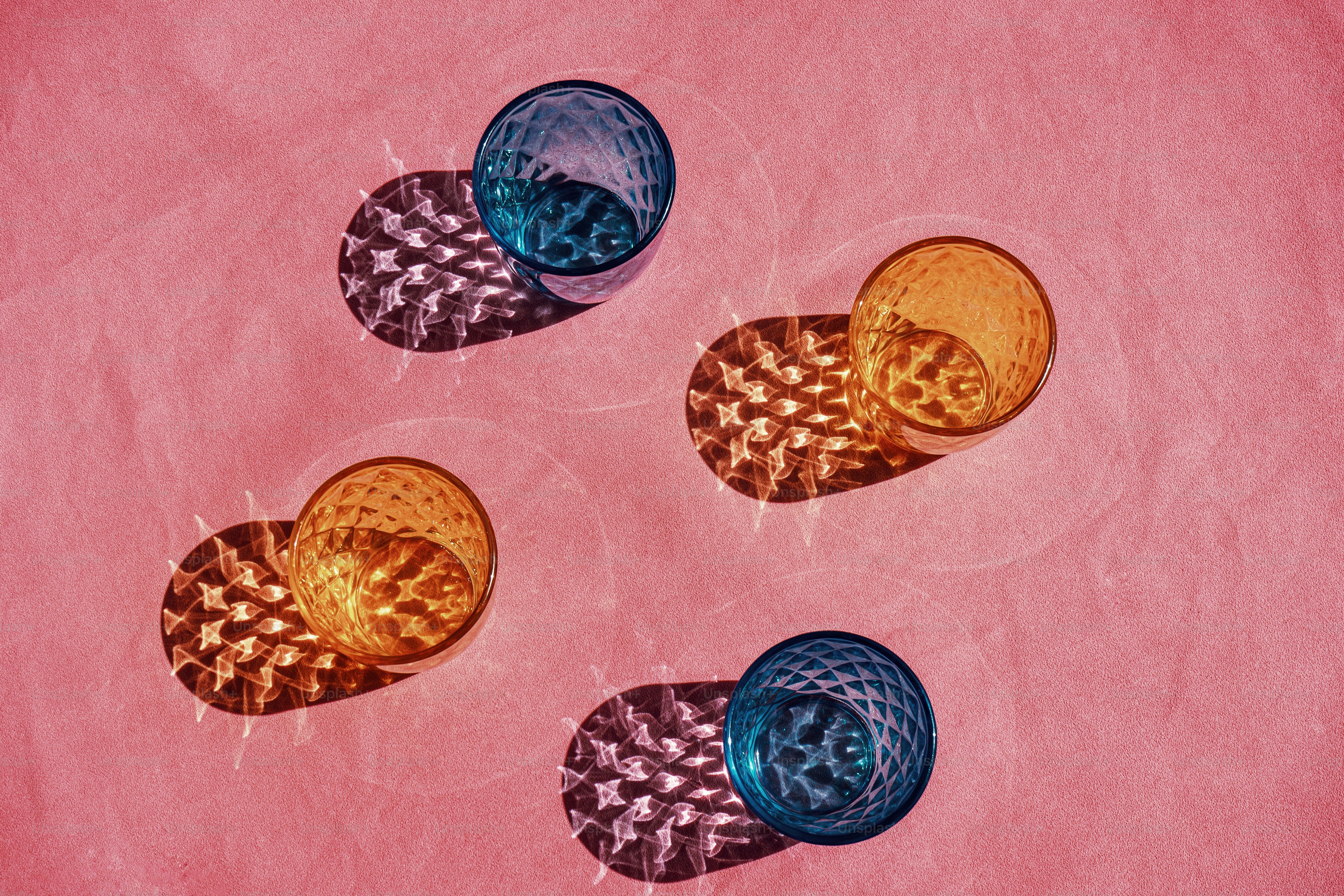 A group of three buttons sitting on top of a pink surface