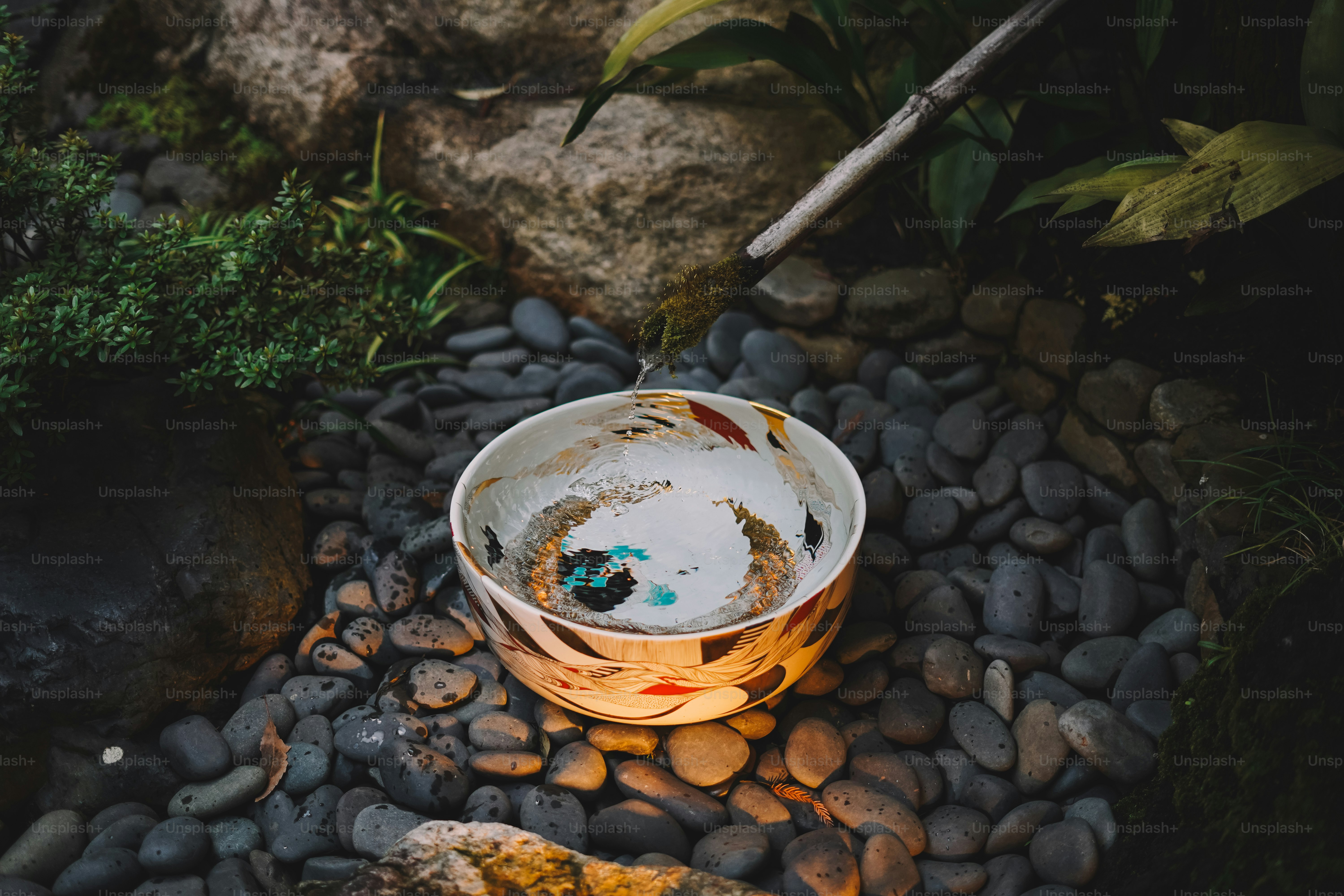 A bucket sitting on top of a pile of rocks