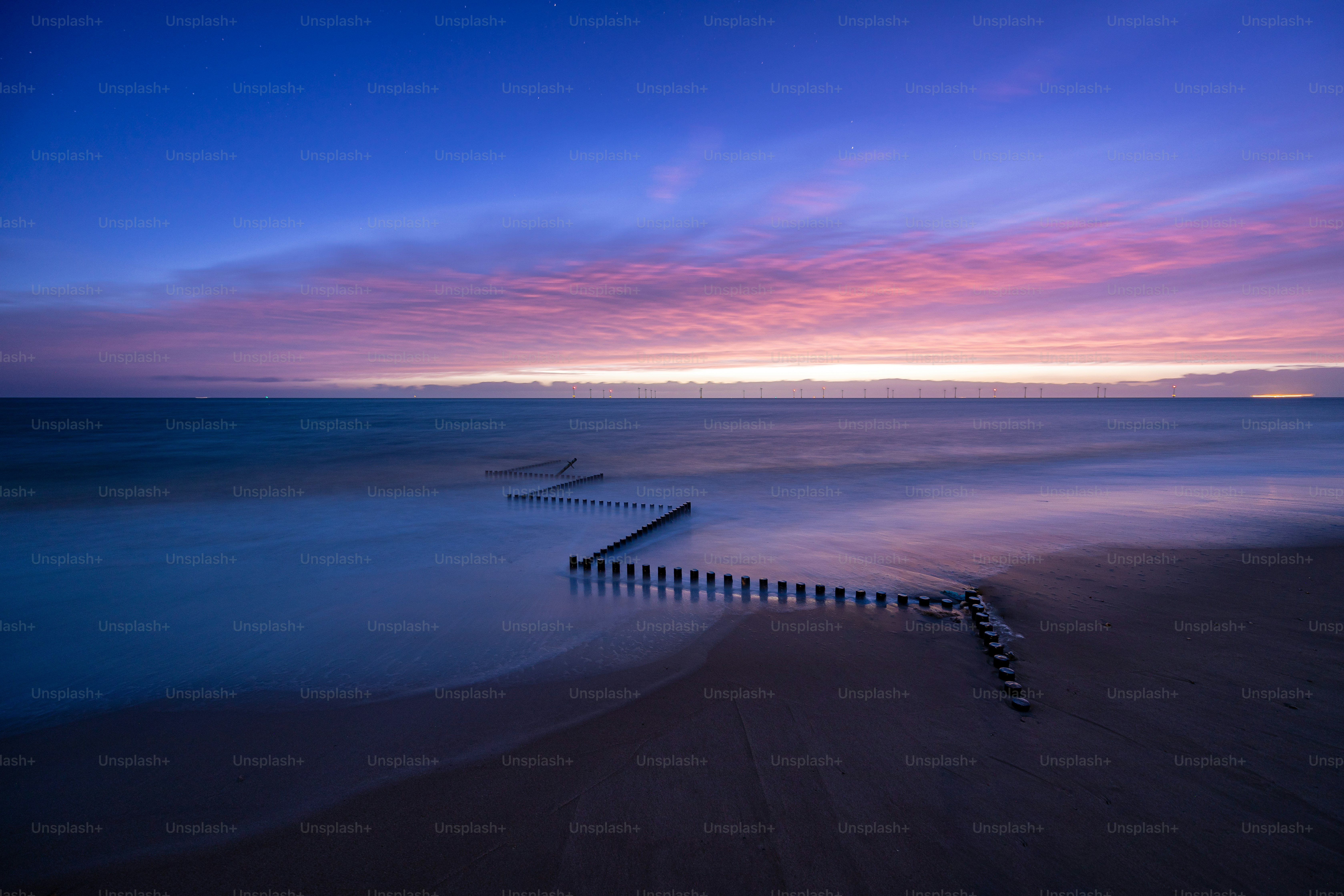 A long exposure photo of a beach at sunset