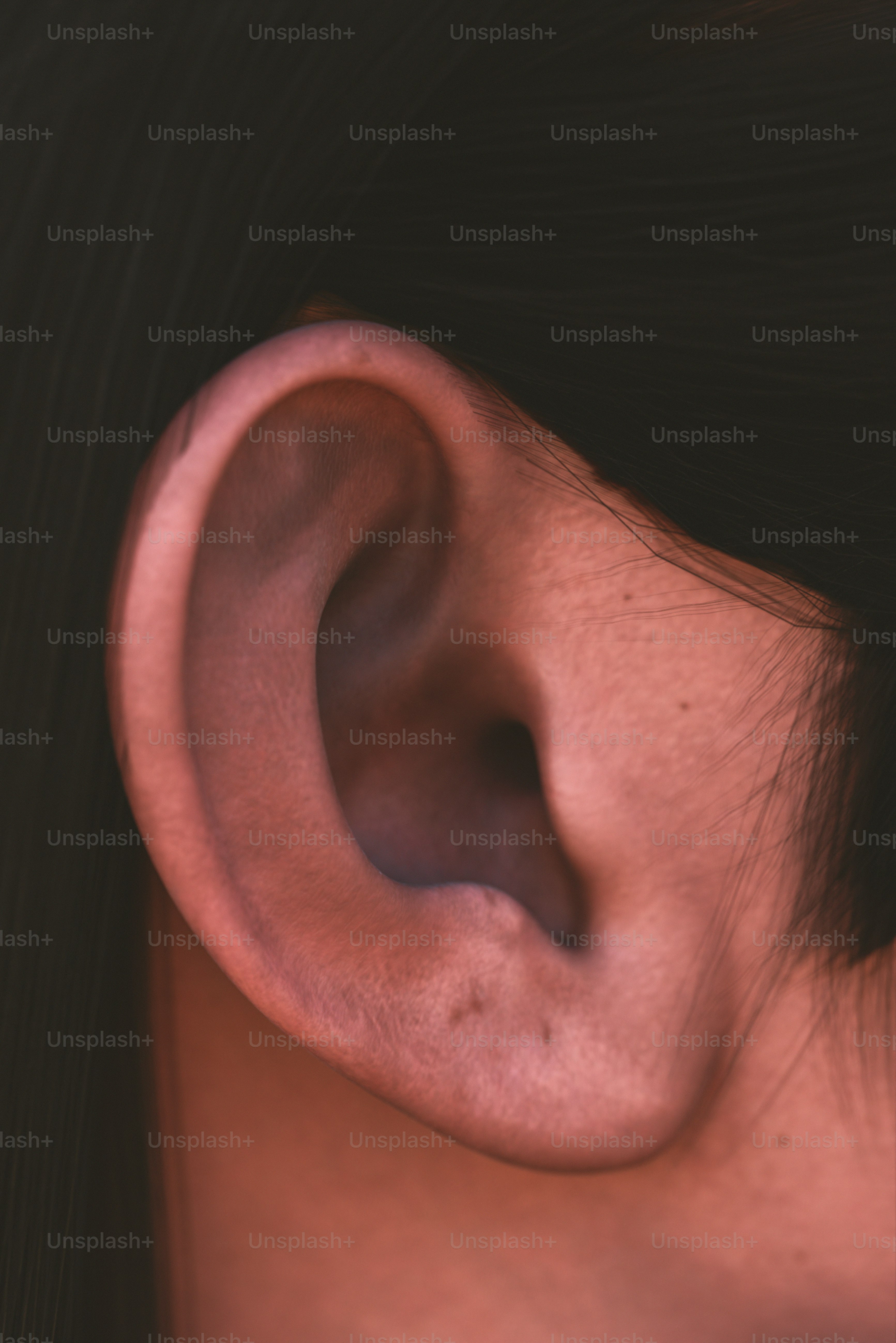 A close up of a woman's ear and earring