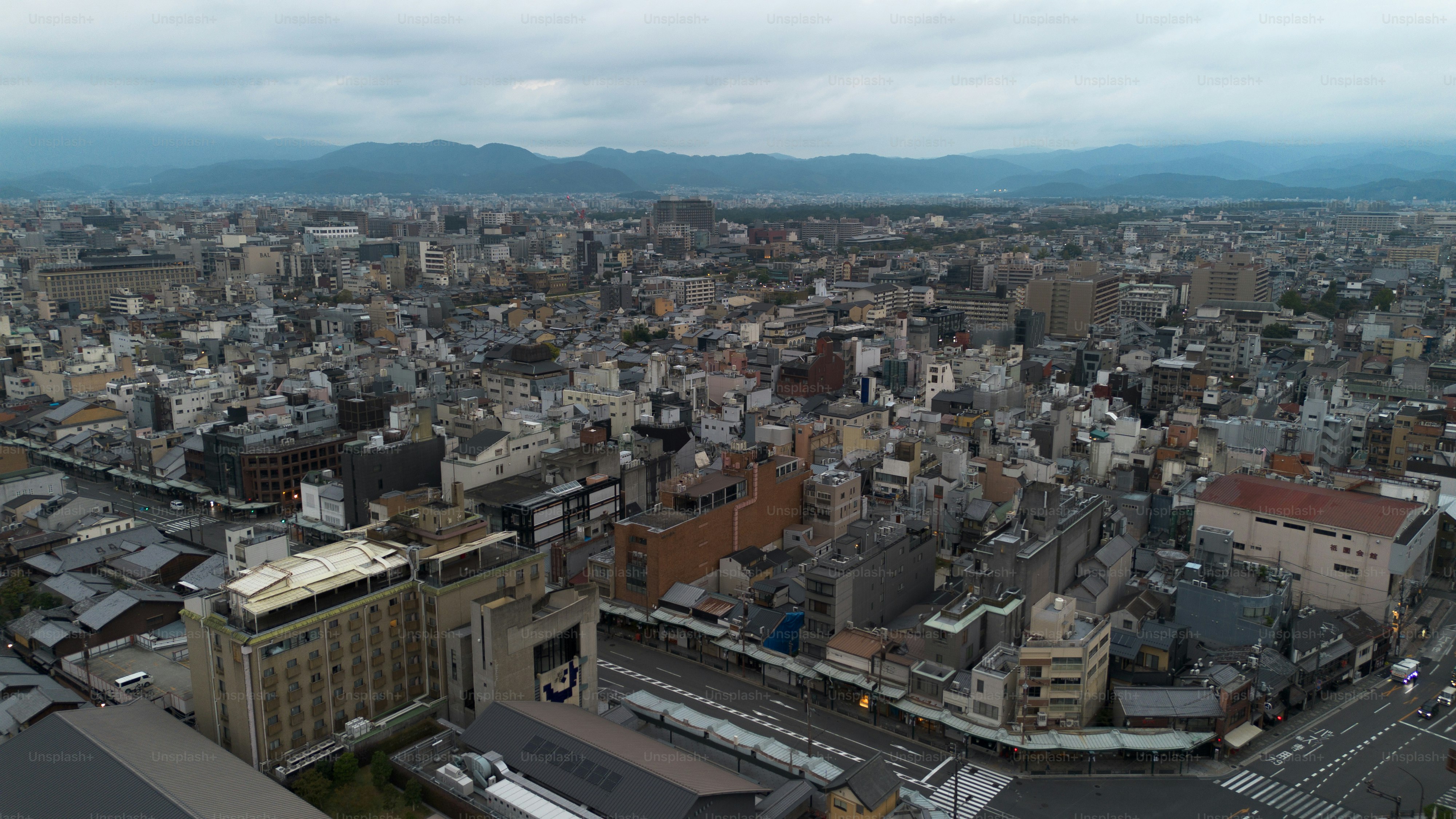 An aerial view of a city with mountains in the background