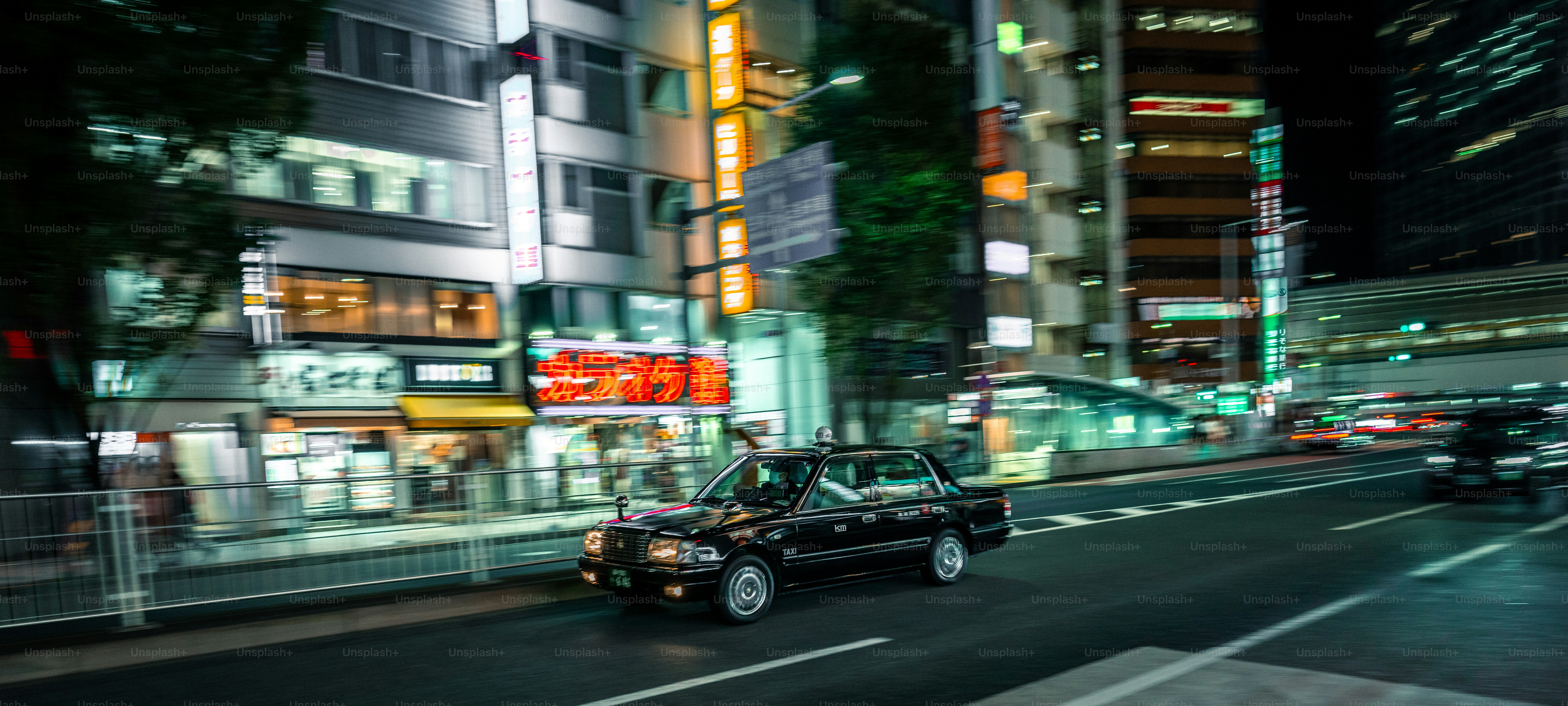 A city street at night with cars and buildings