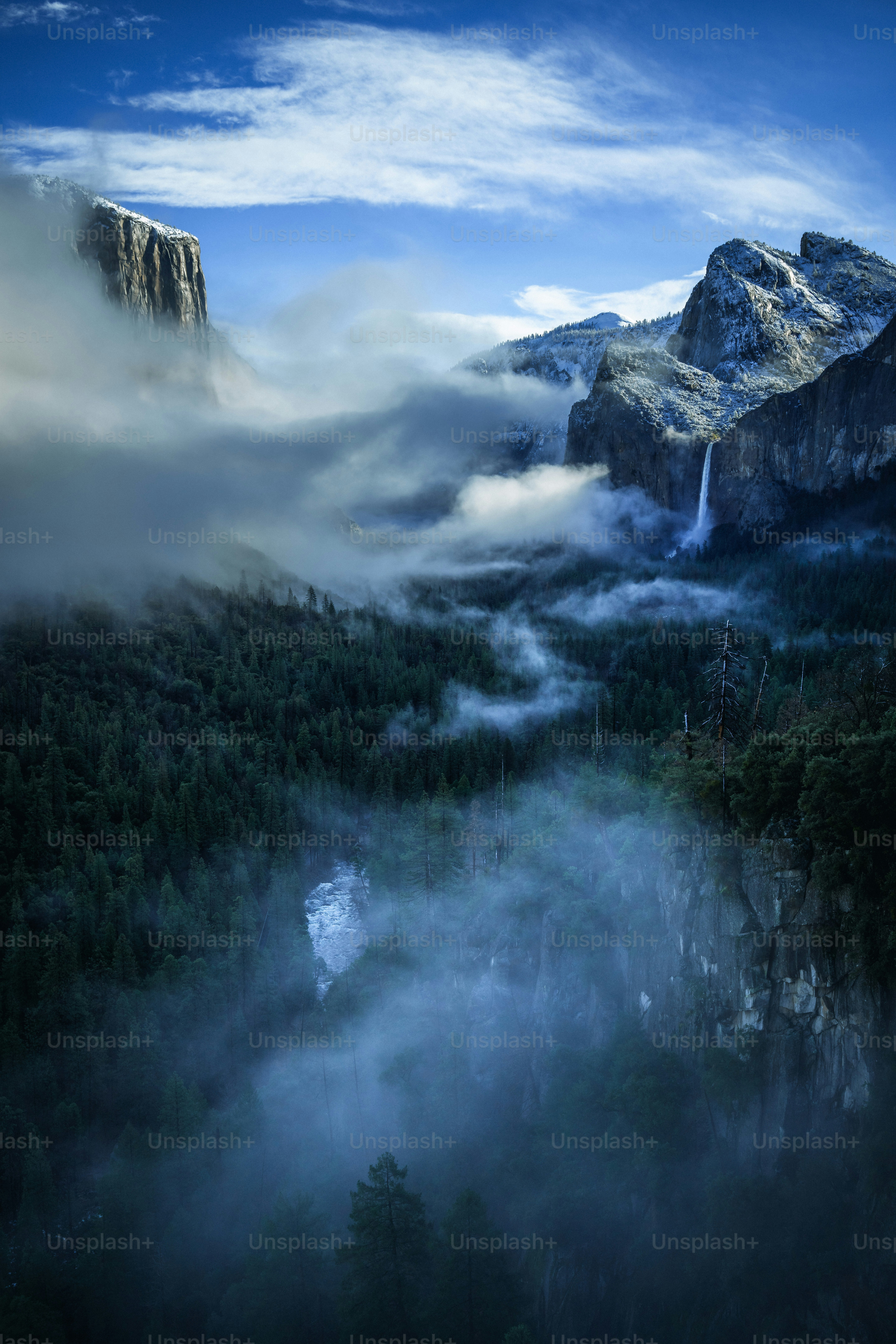 A view of a mountain with a waterfall in the middle of it