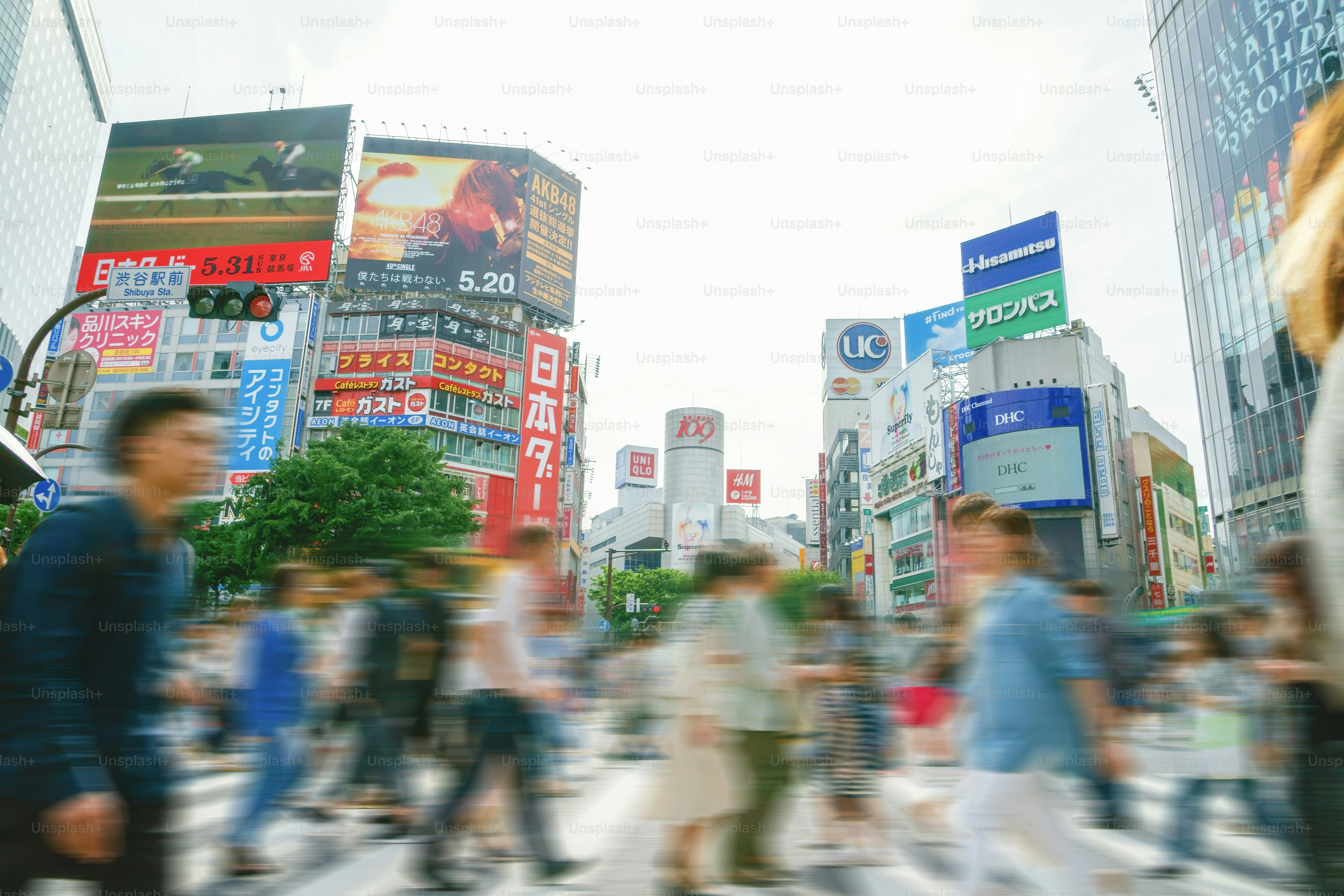 A group of people crossing a street in a city