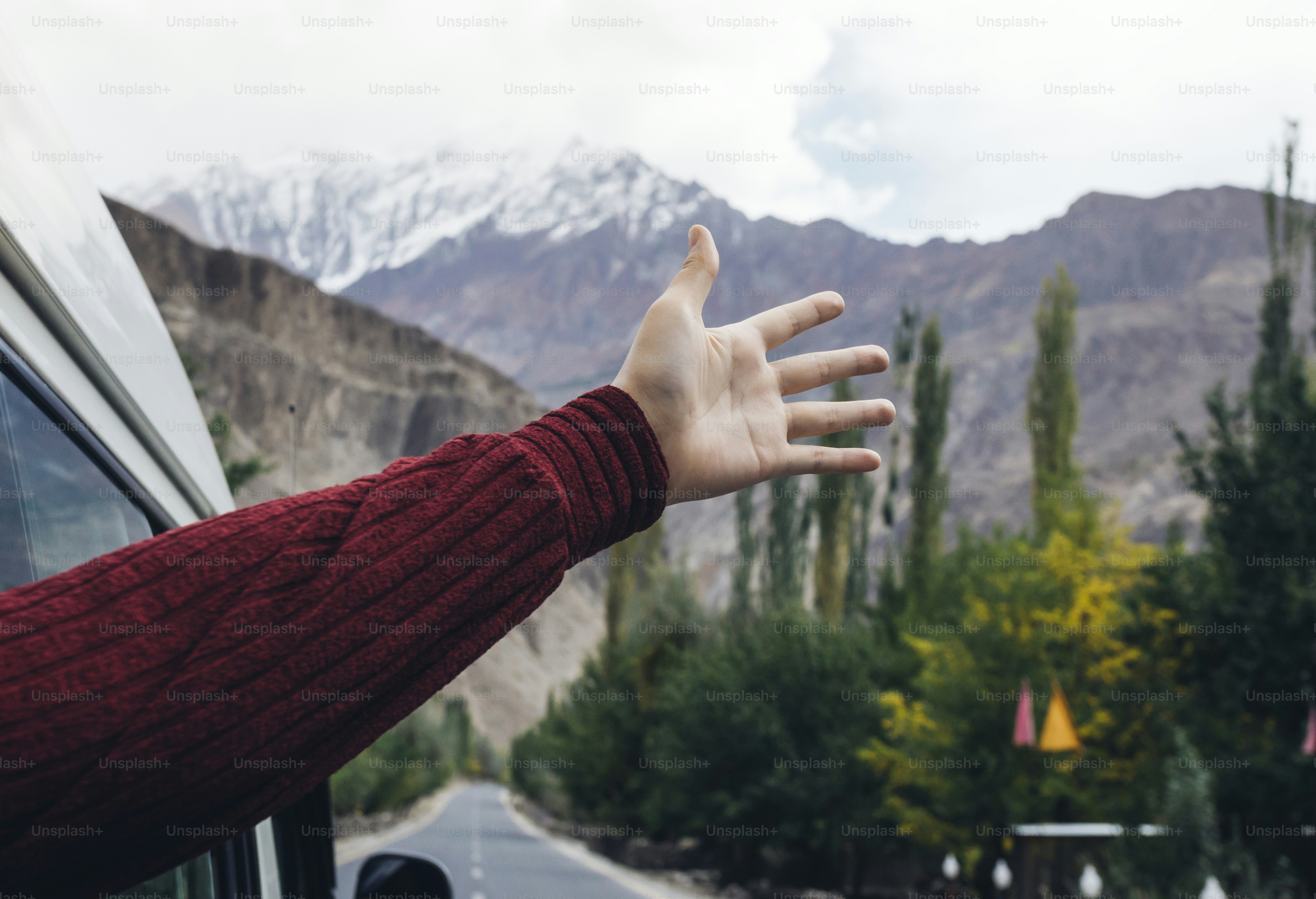 Woman enjoying the cool breeze from the car window