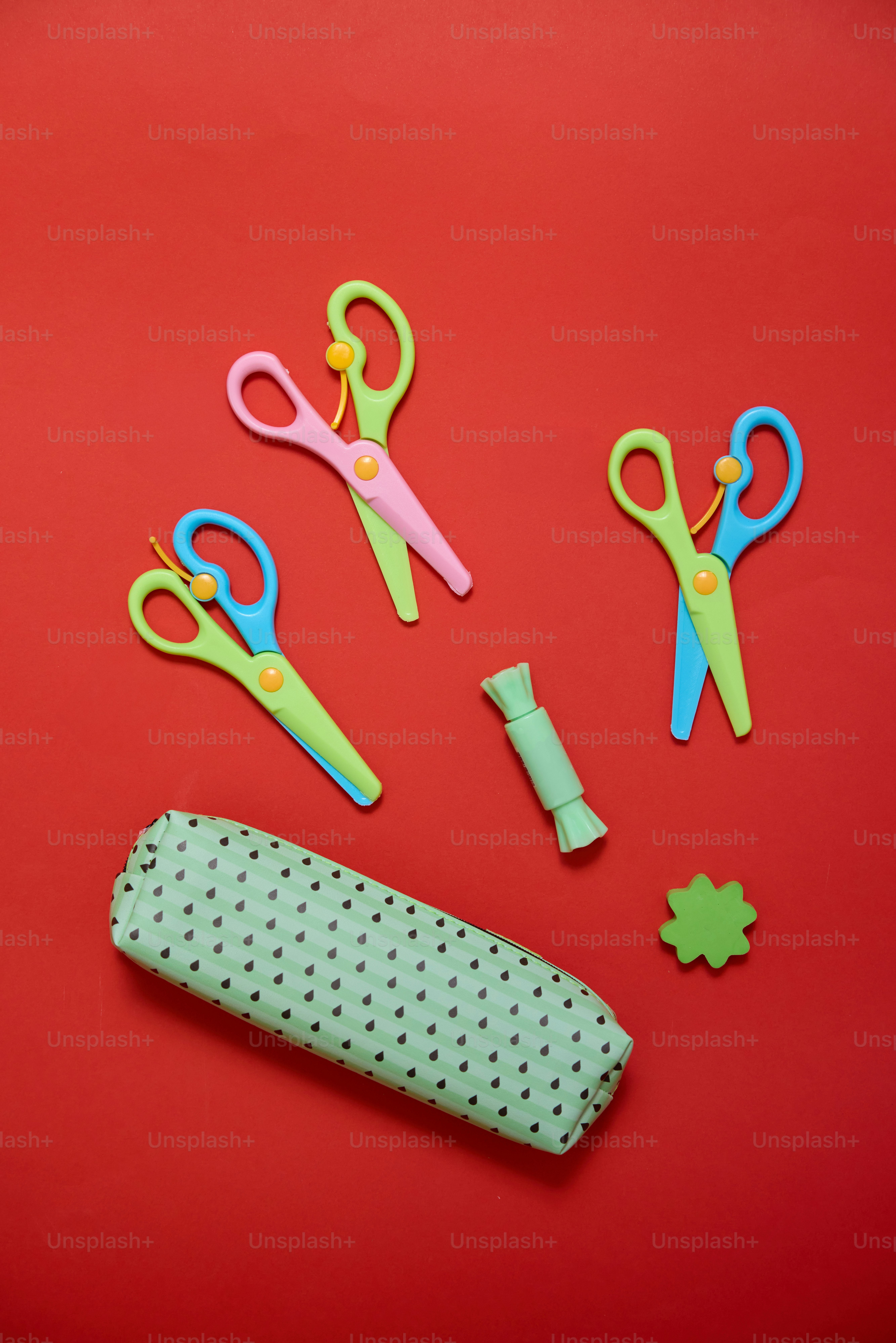 A red surface with scissors and other items