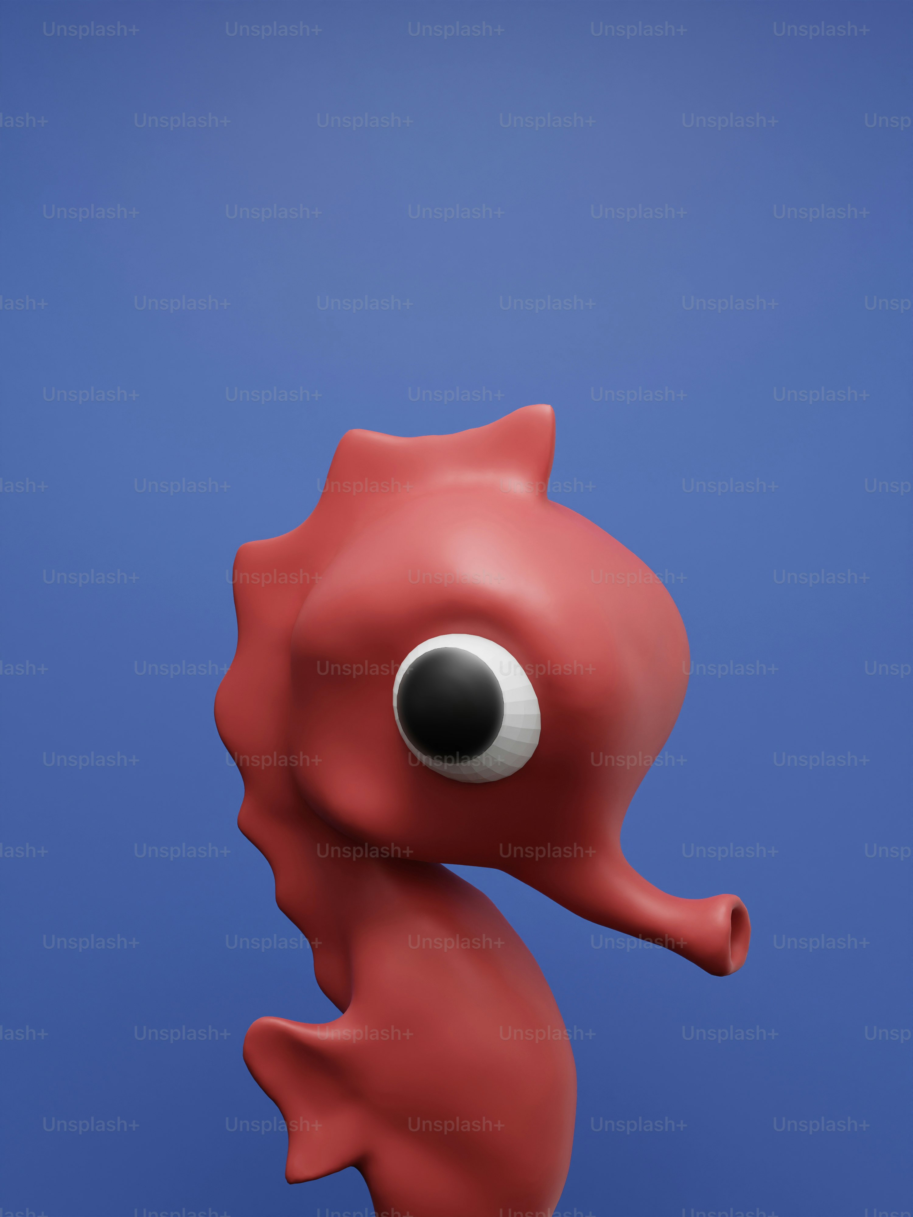 A close up of a red sea horse on a blue background