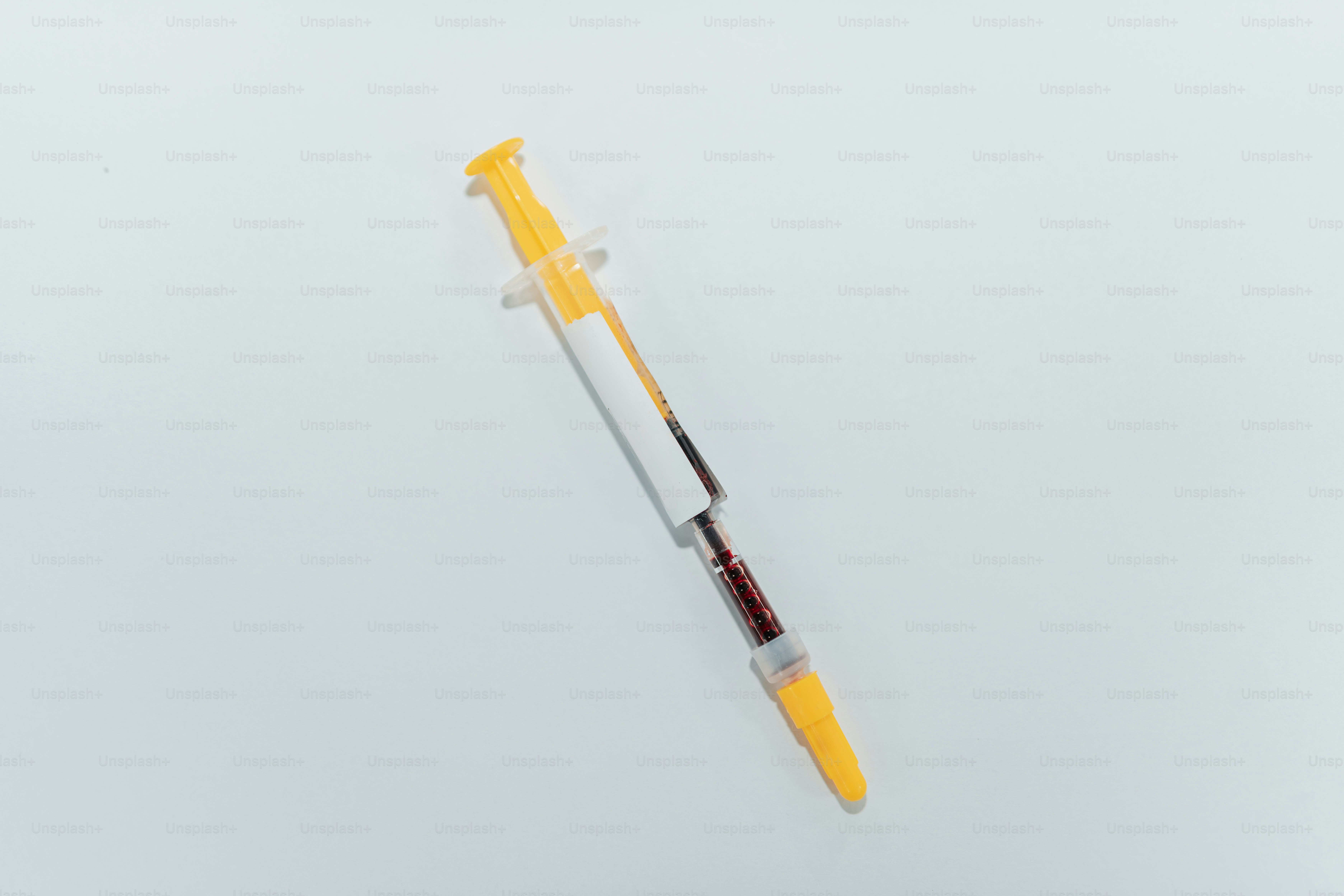 A toothbrush and toothpaste in a yellow cup