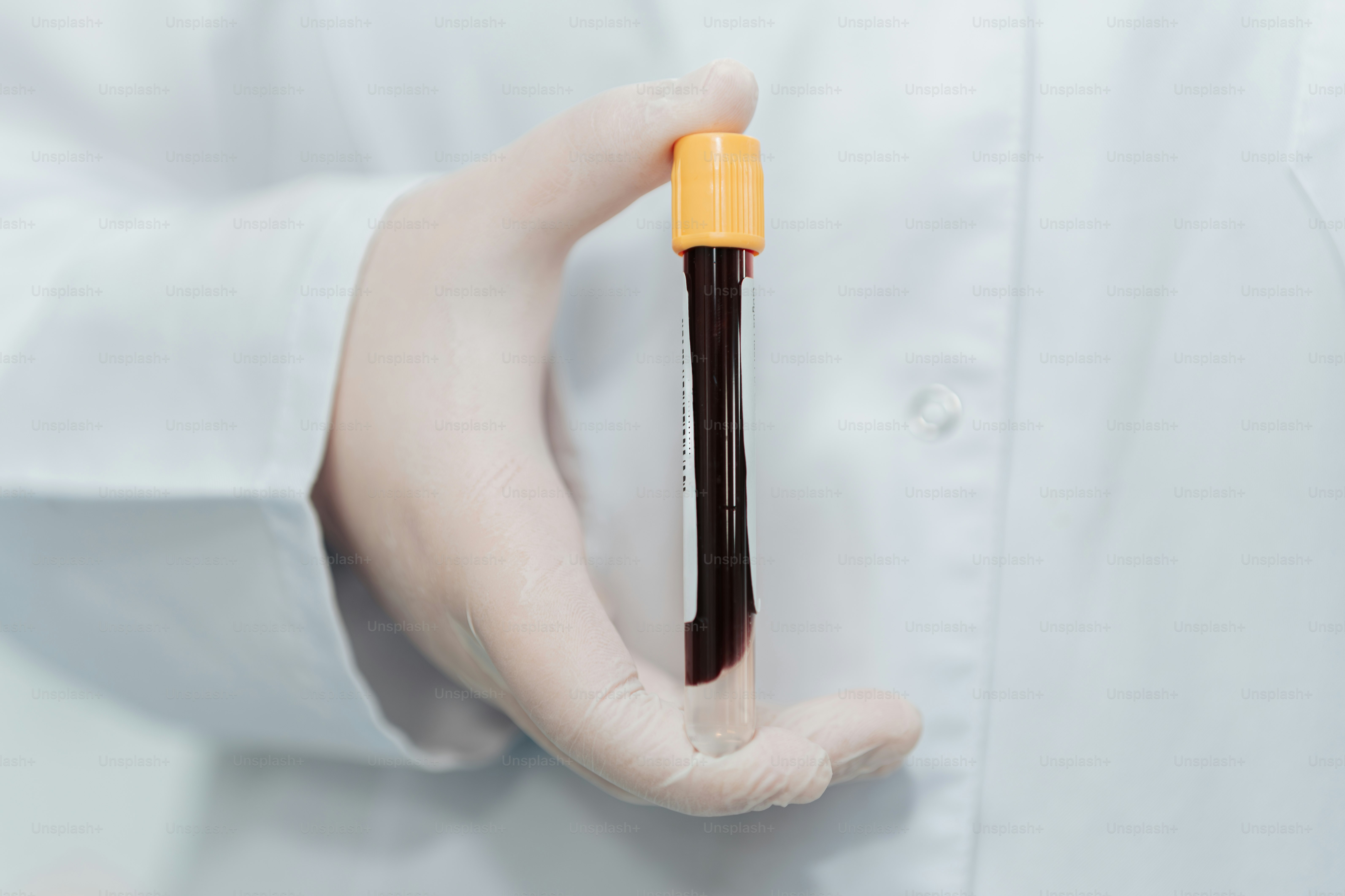 A person in a white shirt holding a small object in their hands