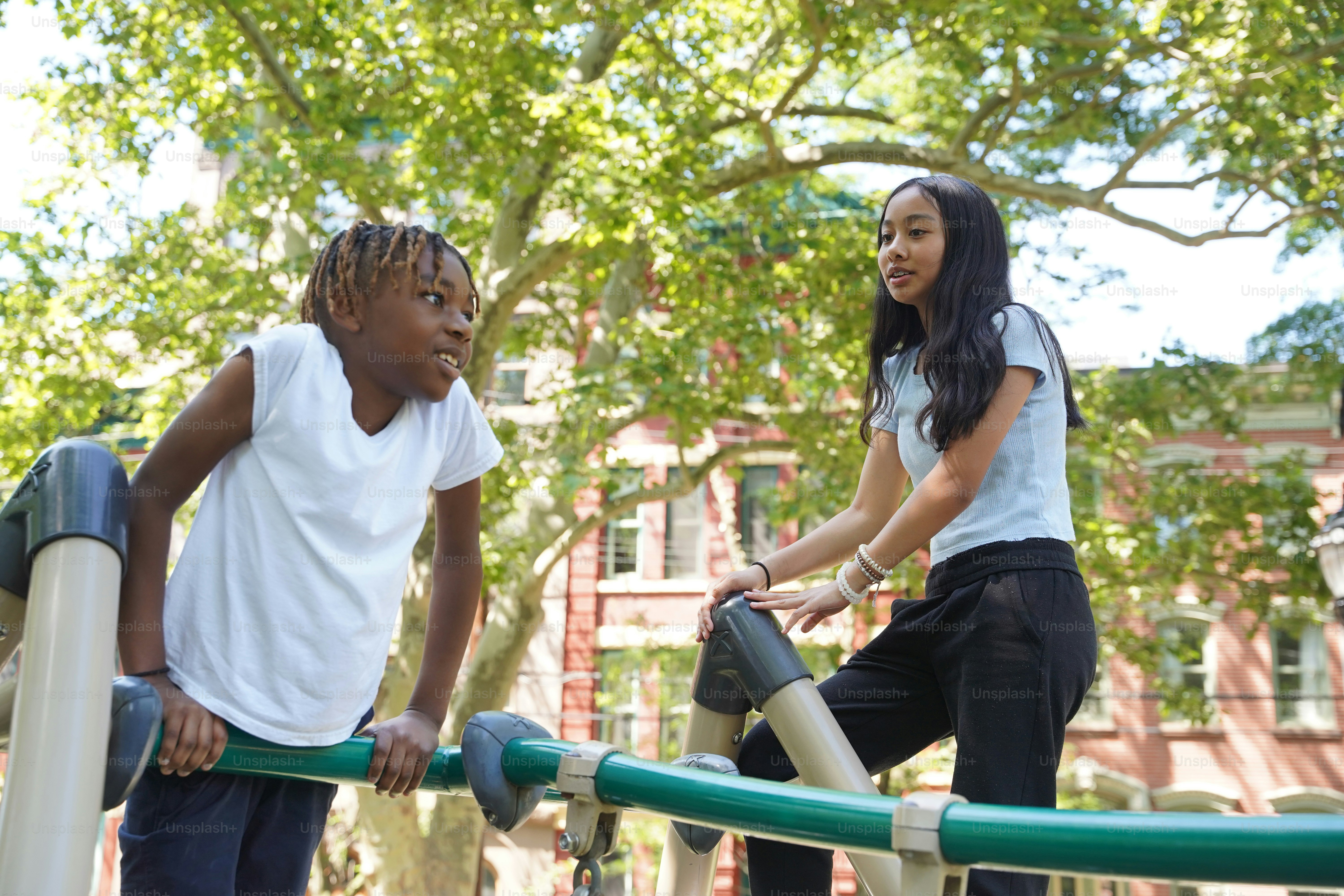 A couple of people standing on top of a playground
