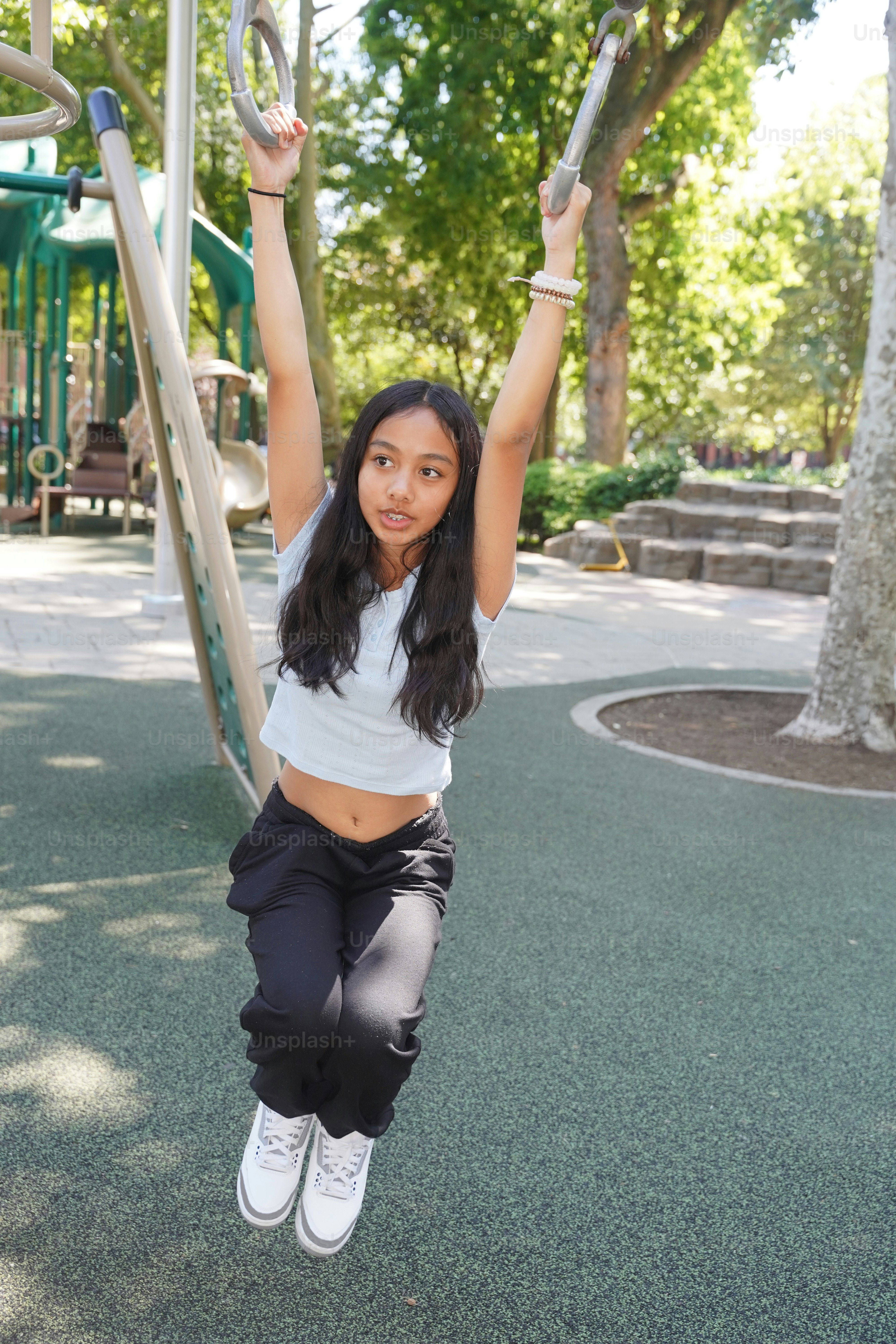 A young woman is swinging on a swing set