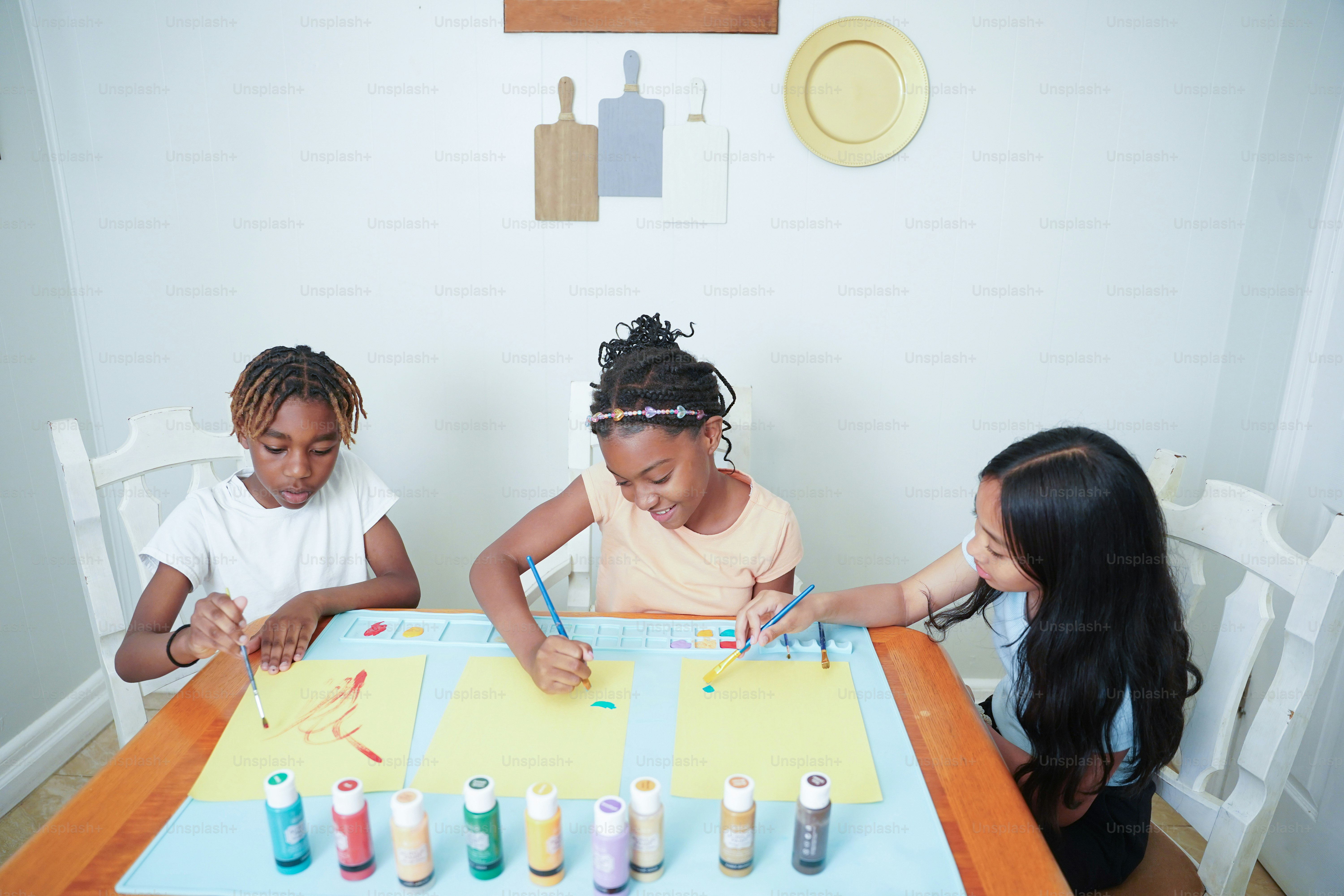A group of children sitting around a table