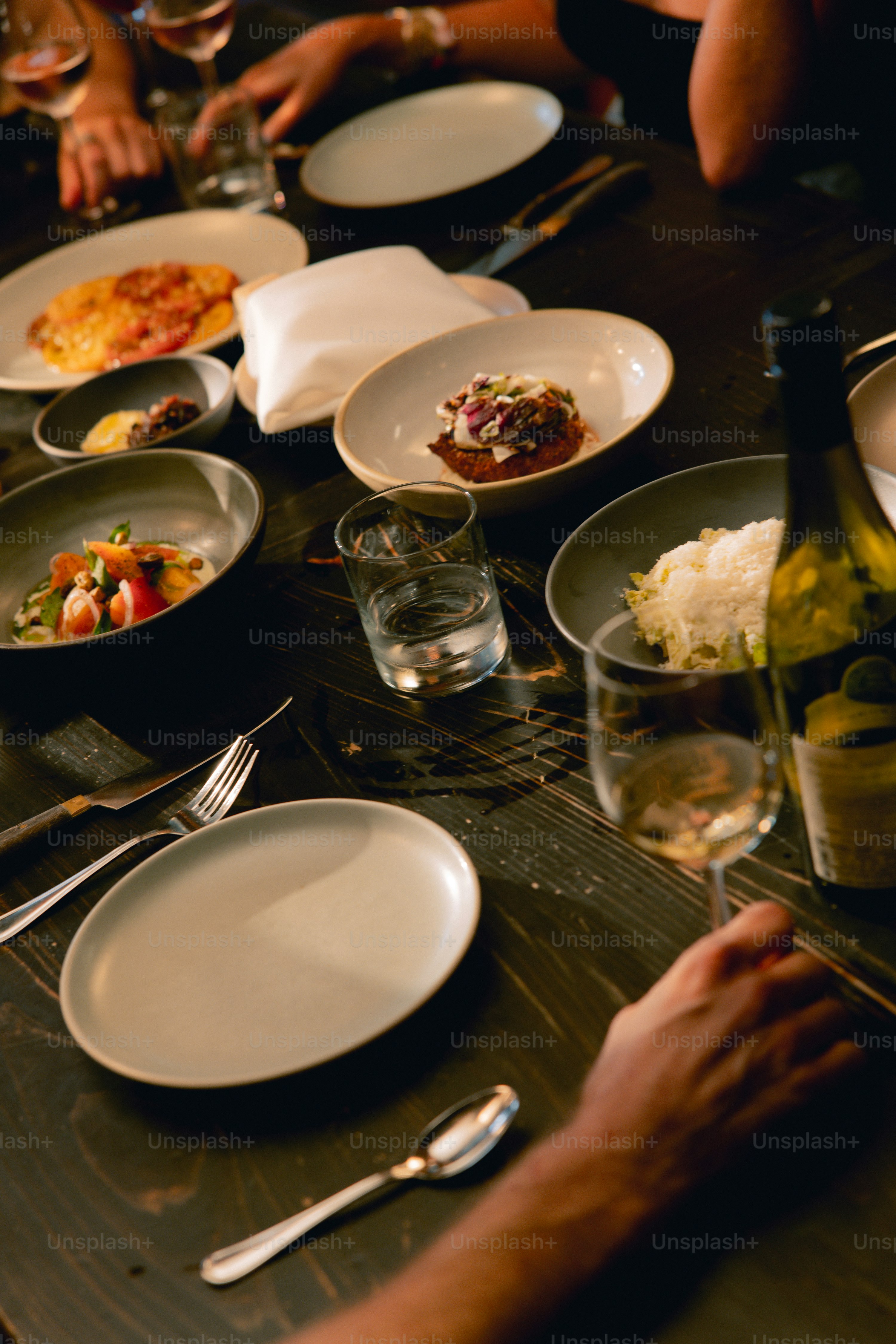 A group of people sitting at a table with plates of food