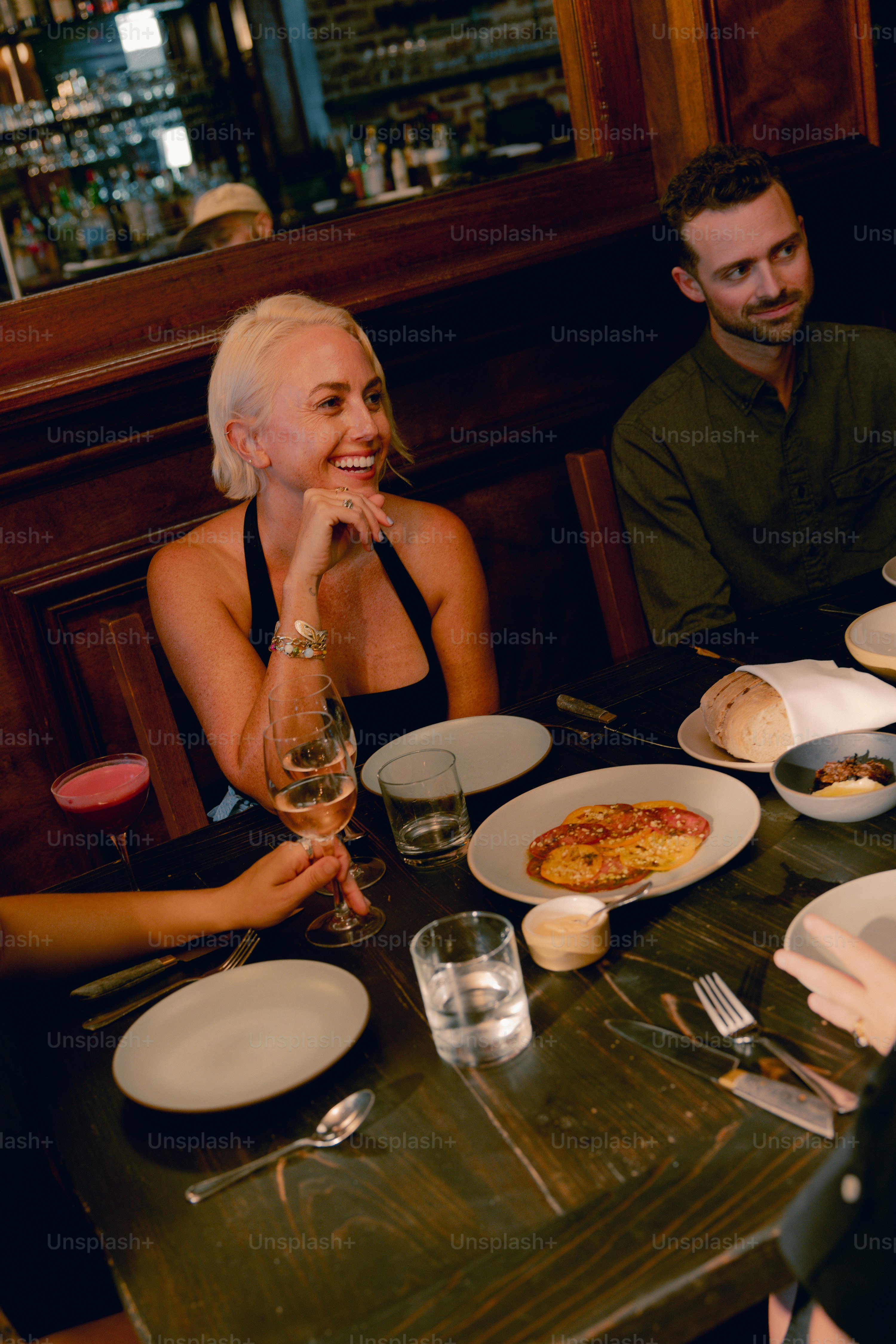 A group of people sitting at a table with plates of food