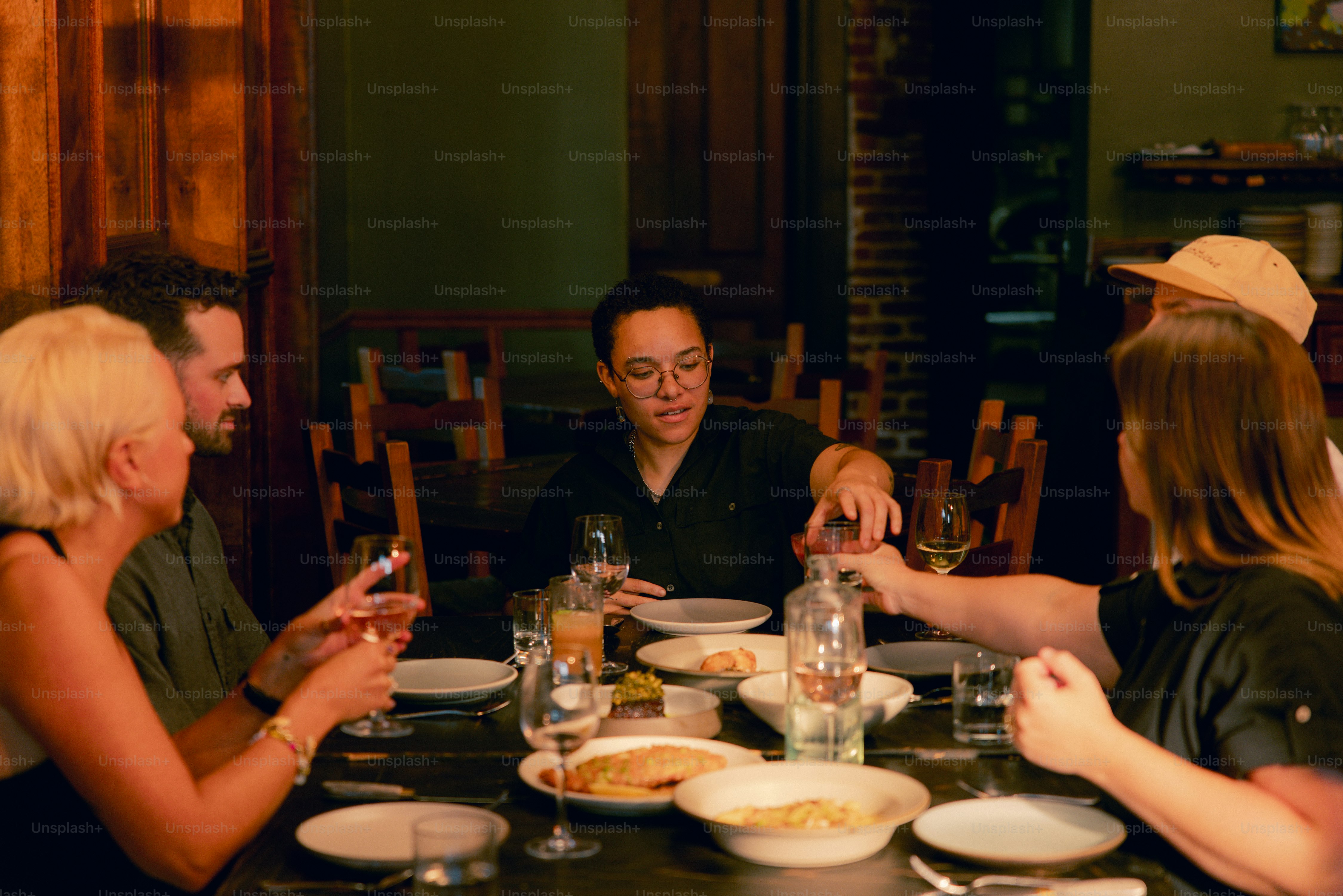 A group of people sitting around a dinner table