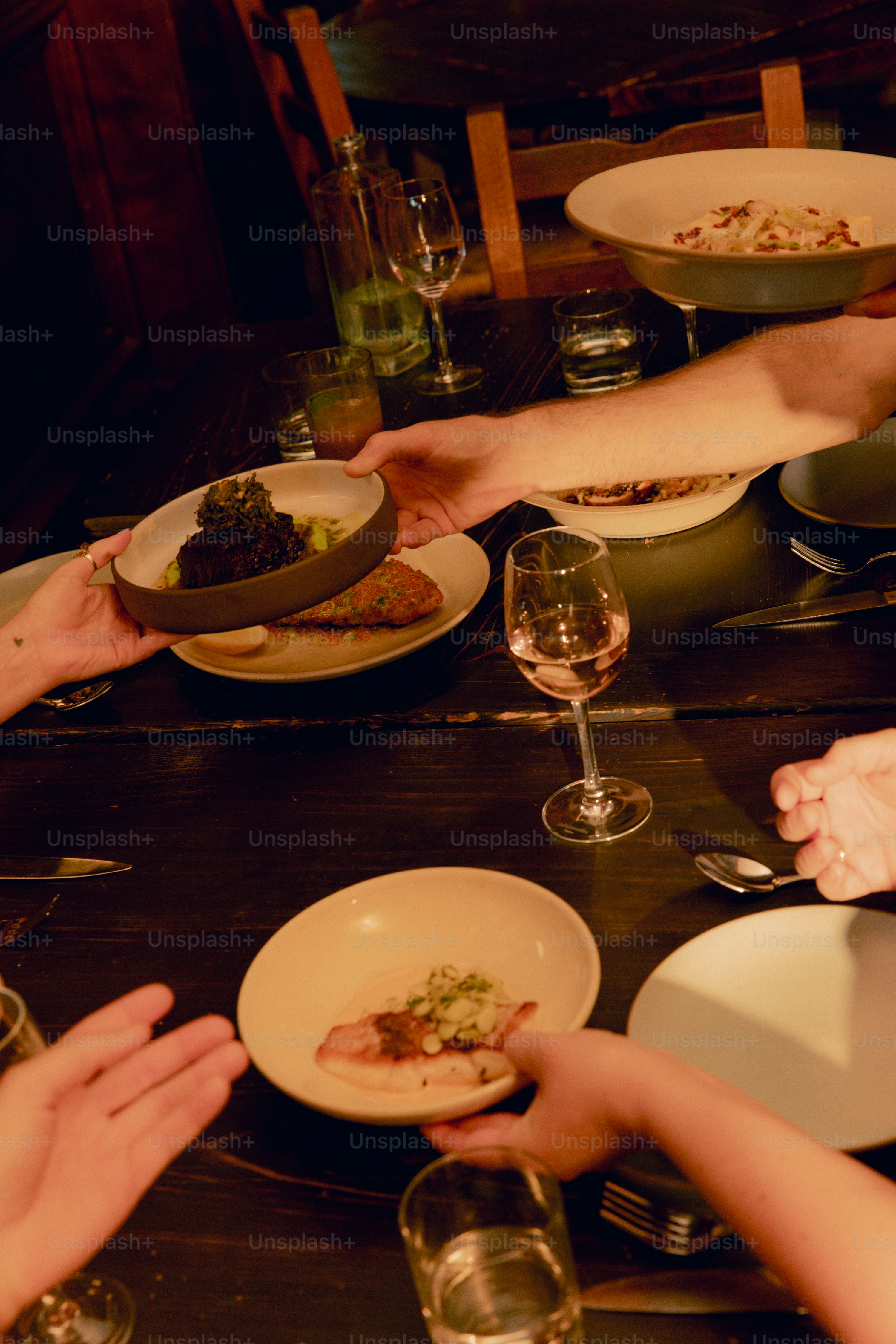 A group of people sitting around a table with plates of food