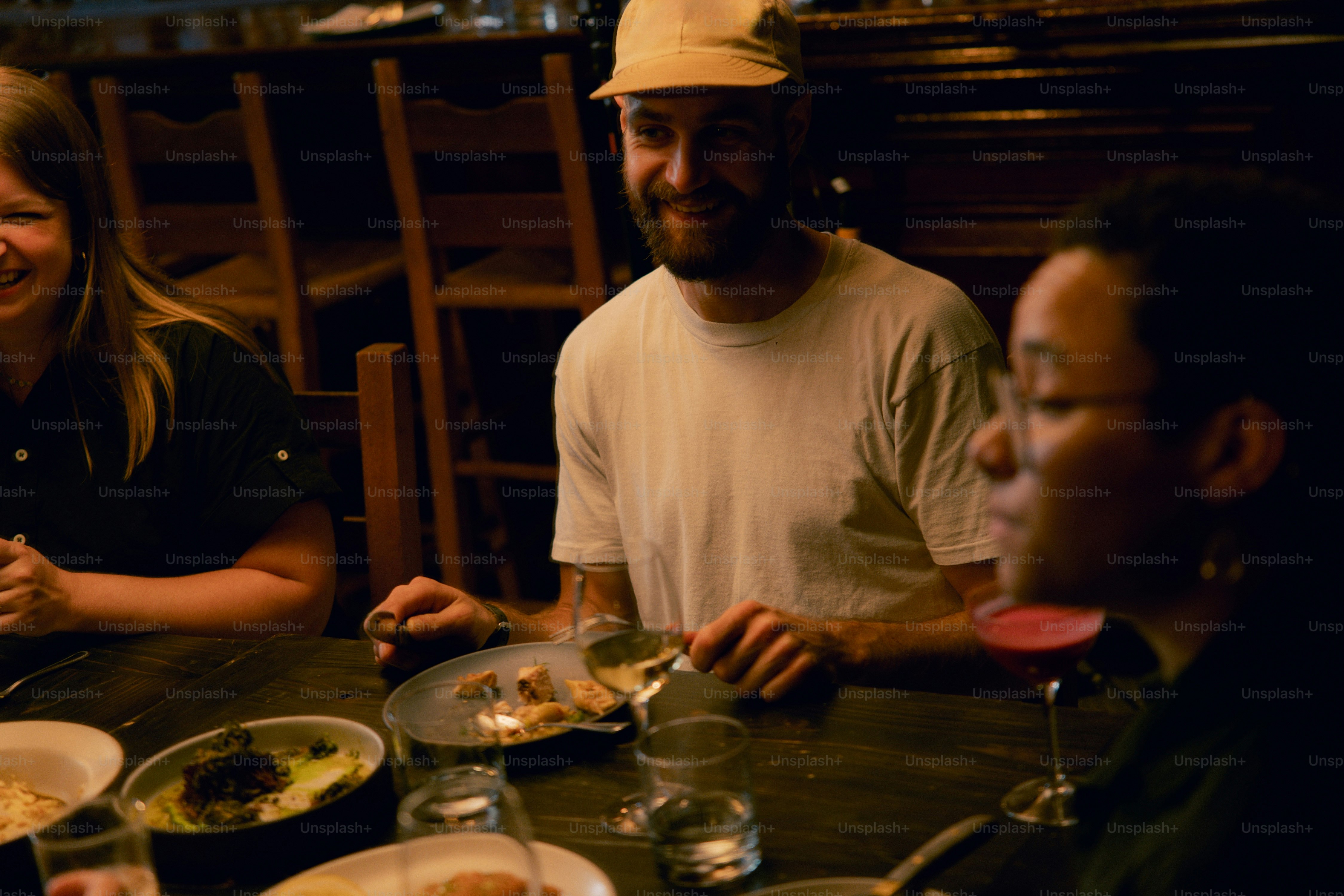 A group of people sitting around a table eating food