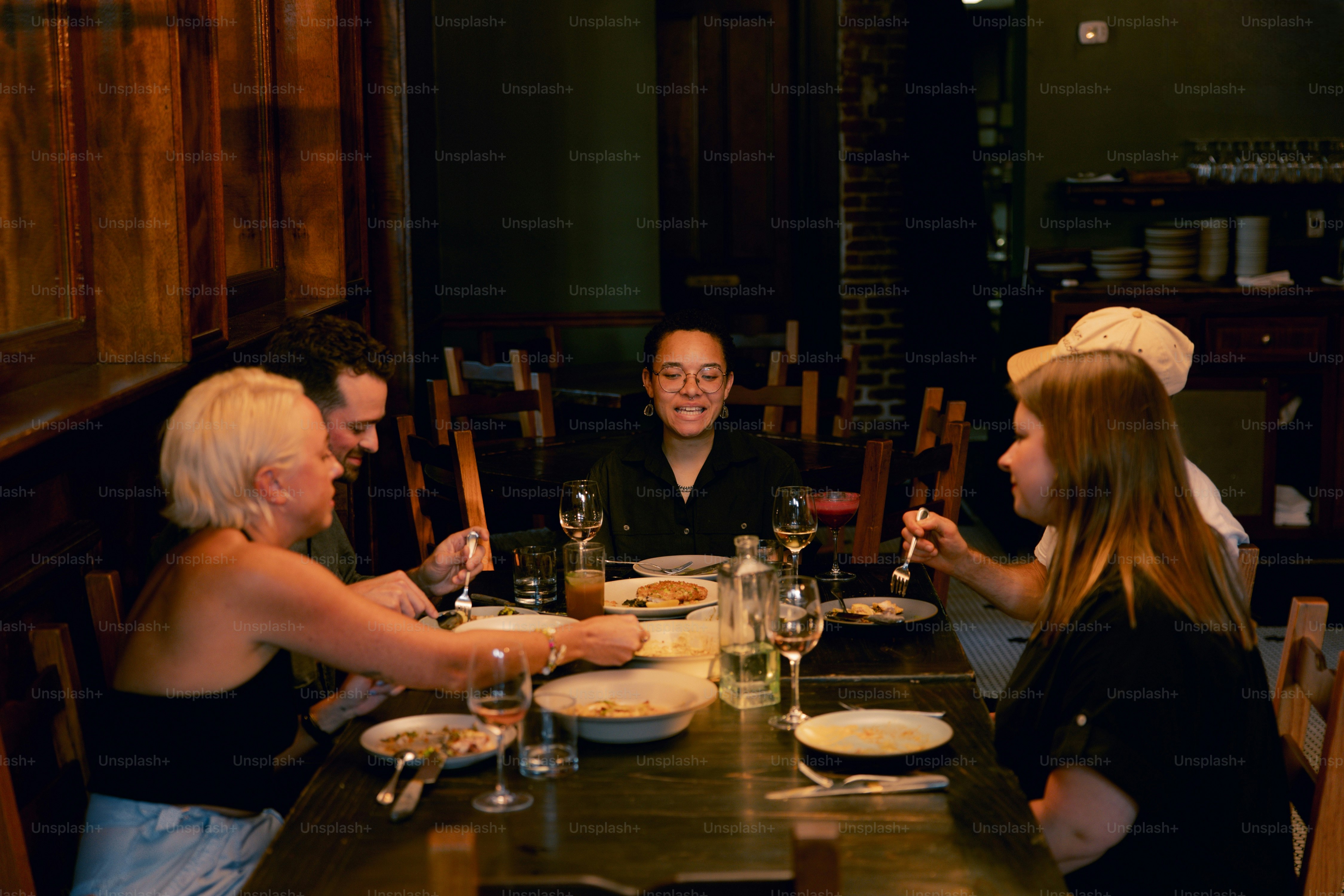 A group of people sitting around a wooden table