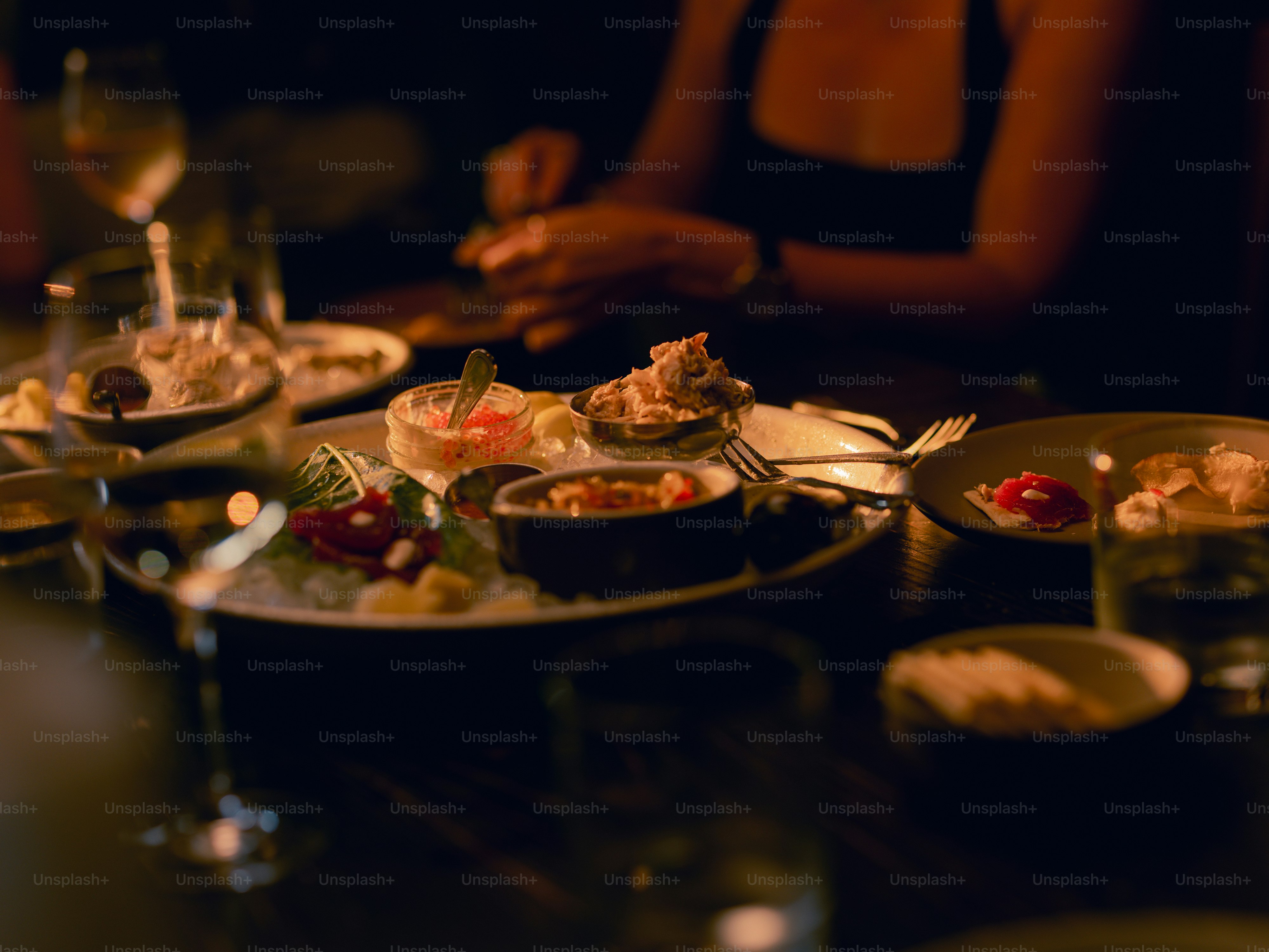 A group of people sitting at a table with plates of food
