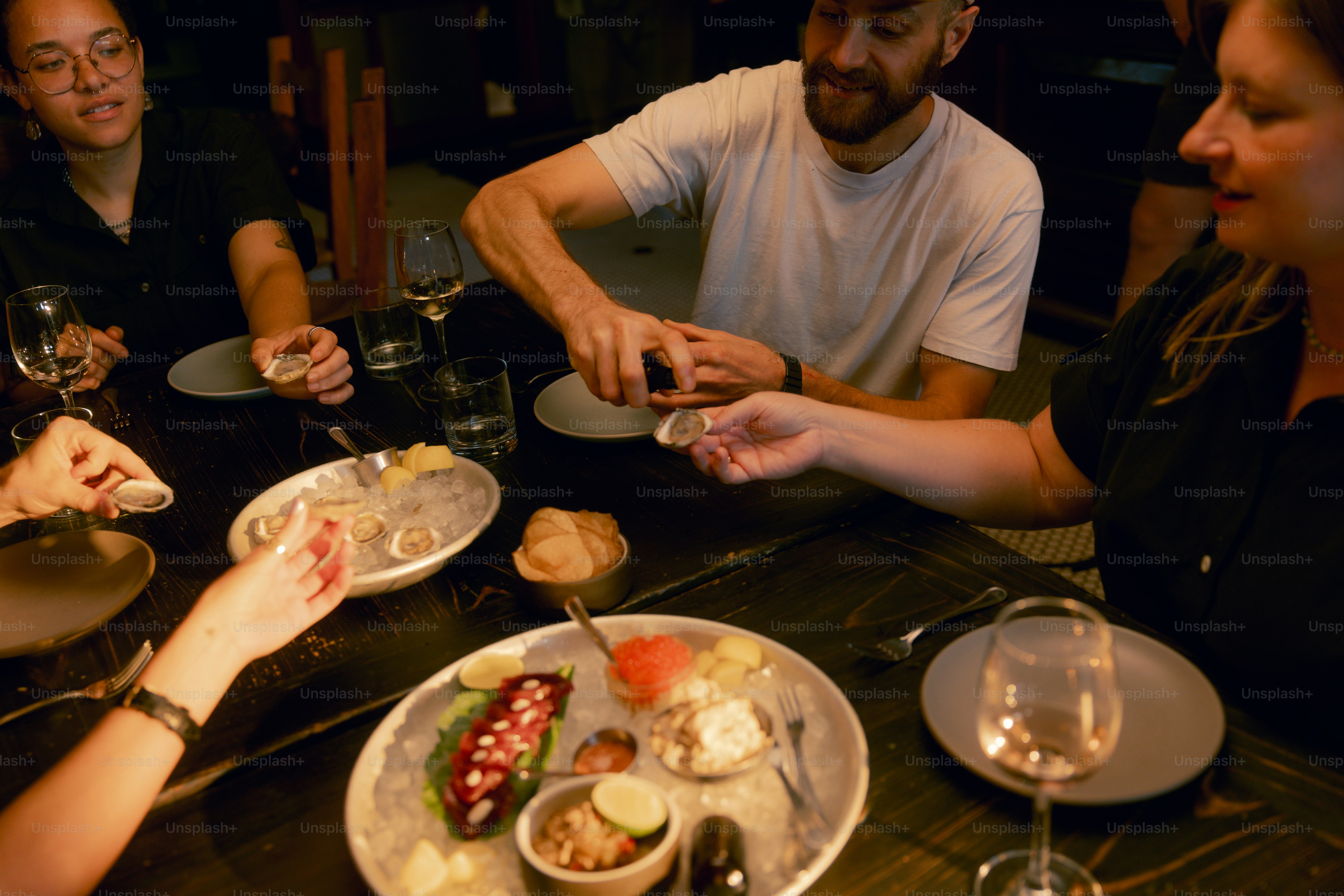 A group of people sitting around a table eating food