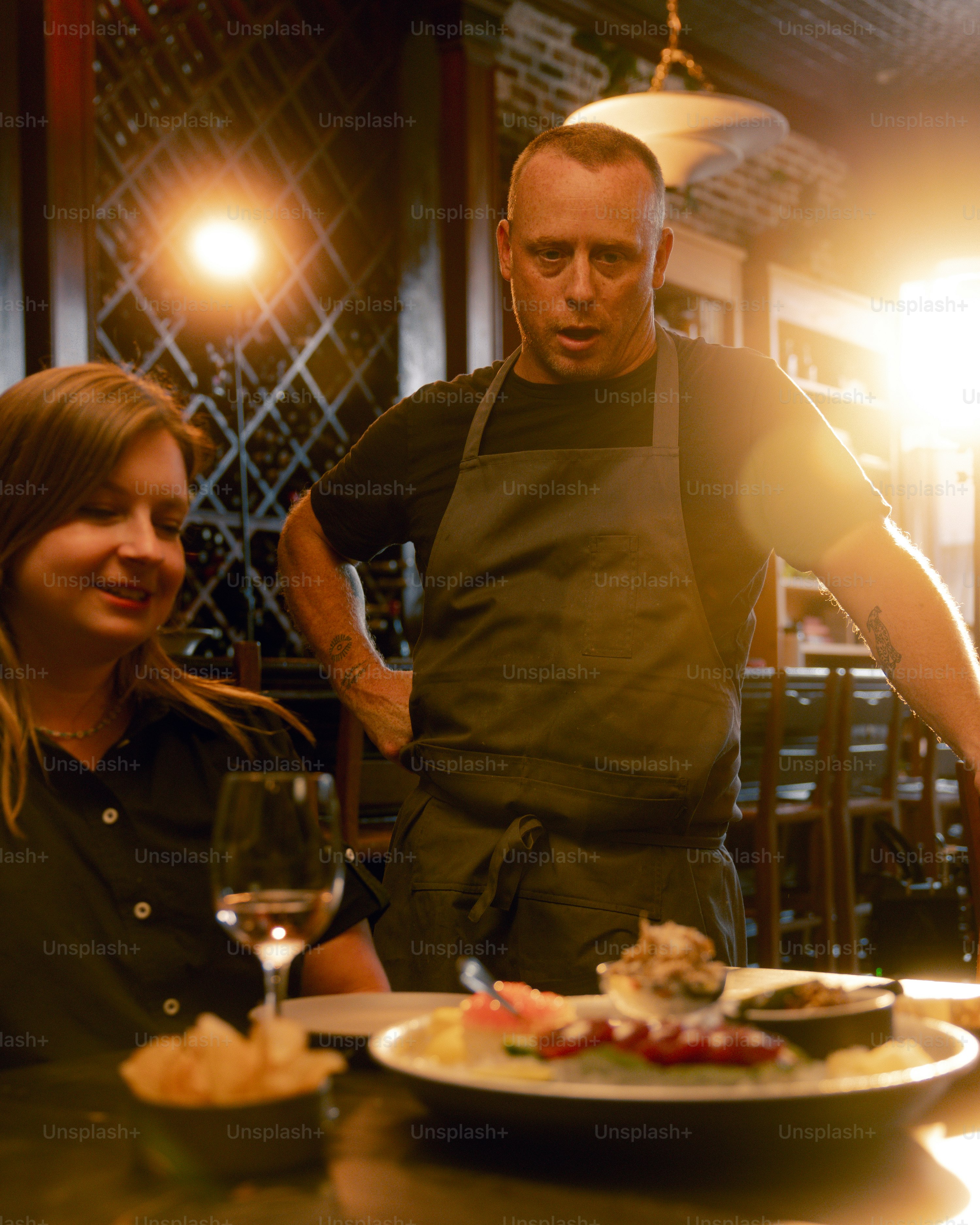 A man and a woman standing in front of a plate of food