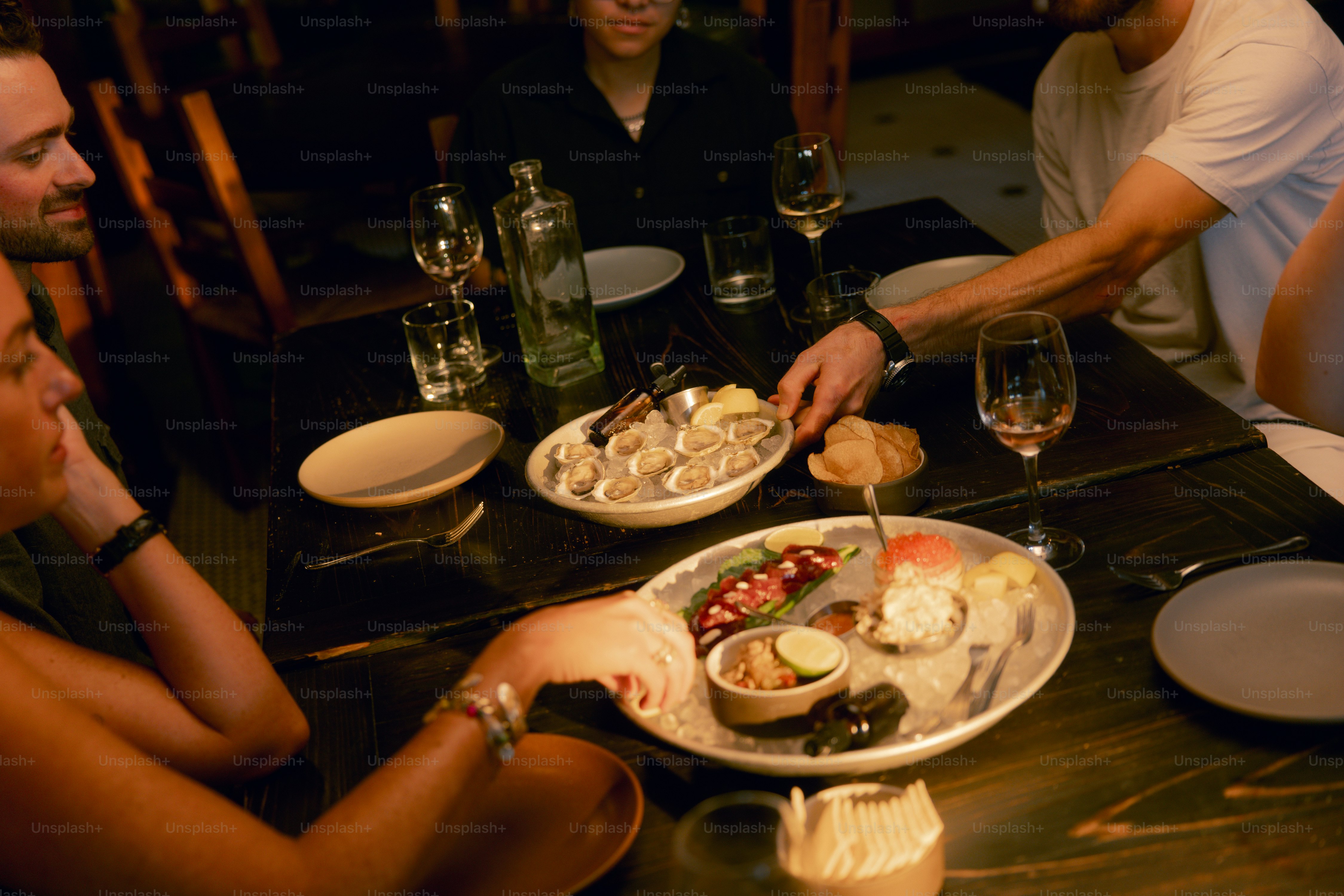 A group of people sitting around a table eating food
