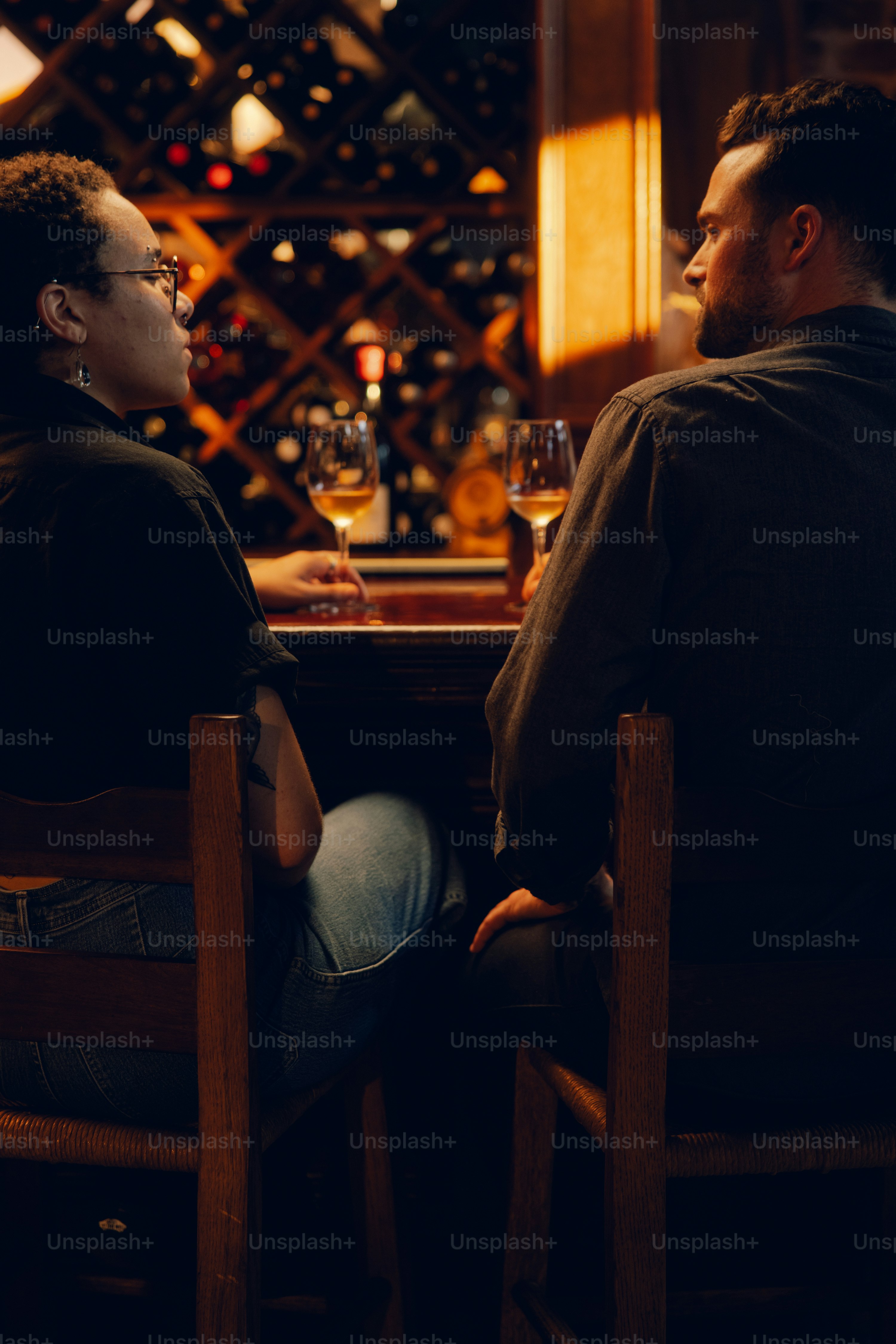 A man and a woman sitting at a table with wine glasses photo – Dinner ...
