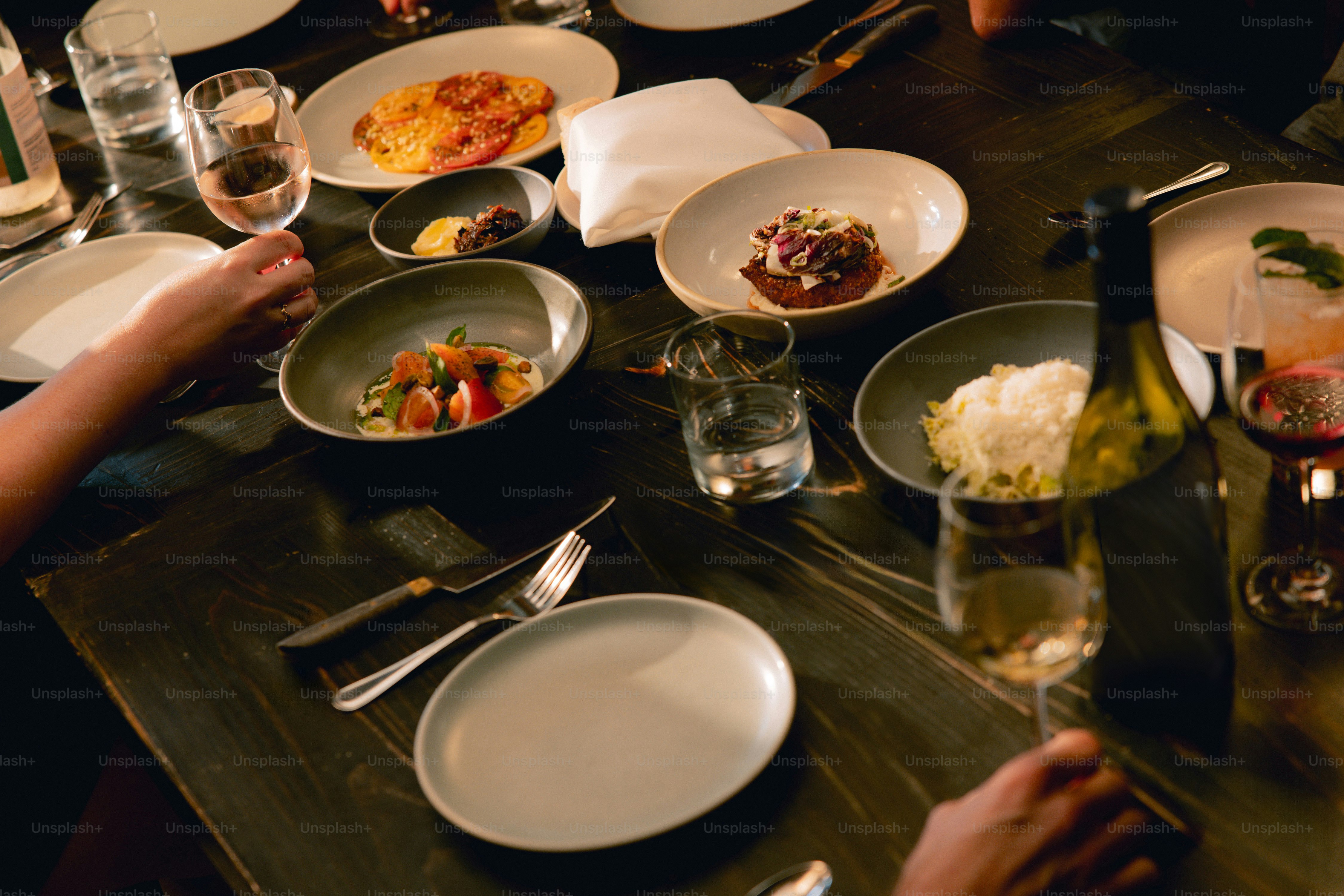 A group of people sitting at a table with plates of food