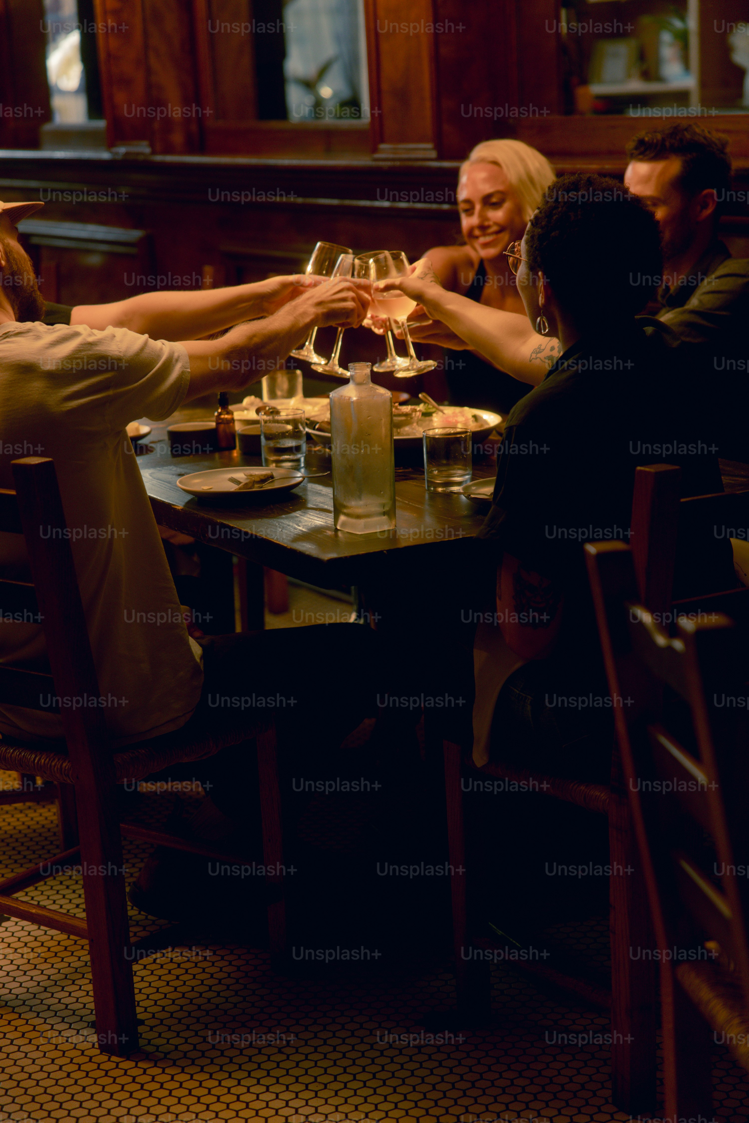 A group of people sitting at a table with wine glasses