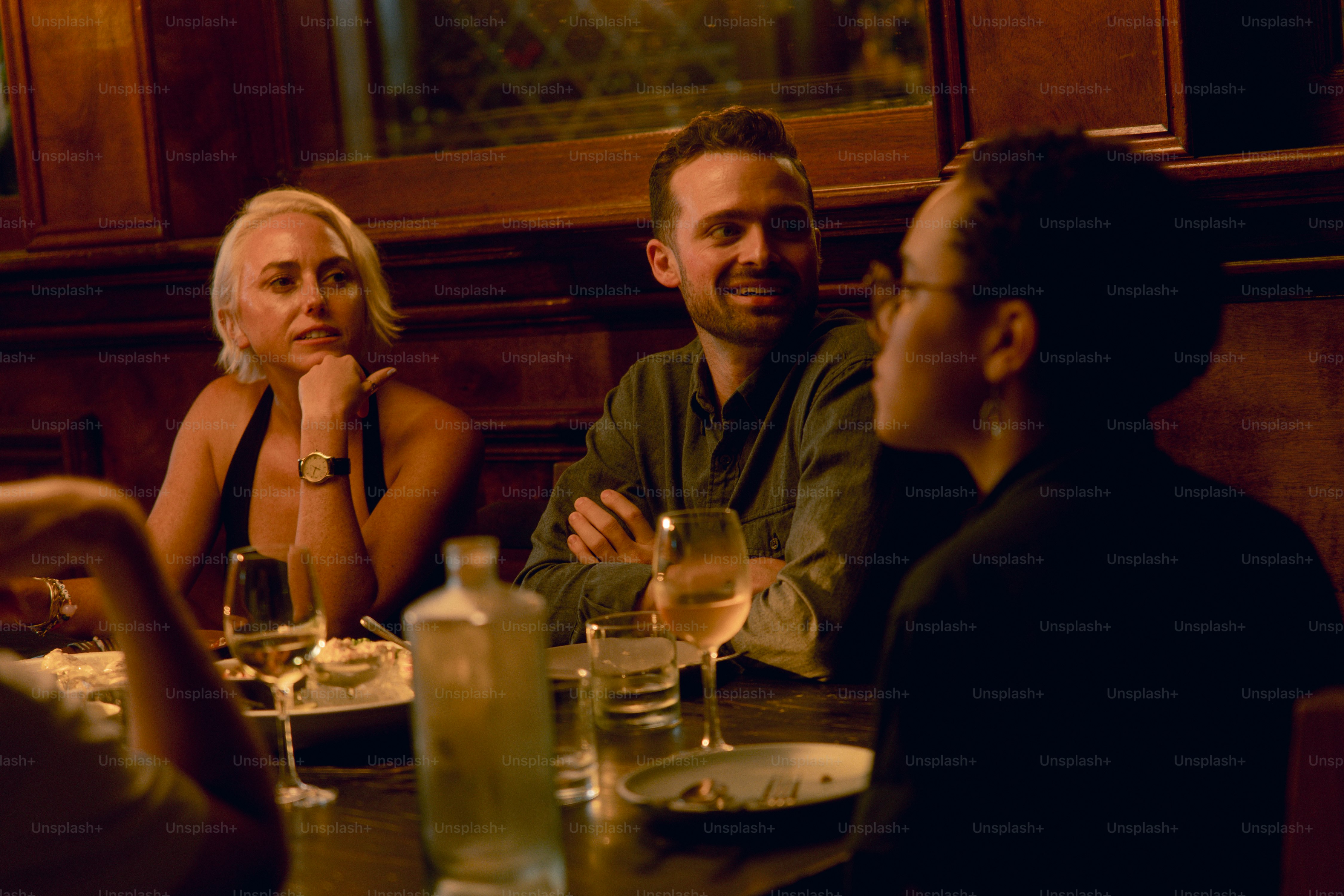 A group of people sitting around a dinner table